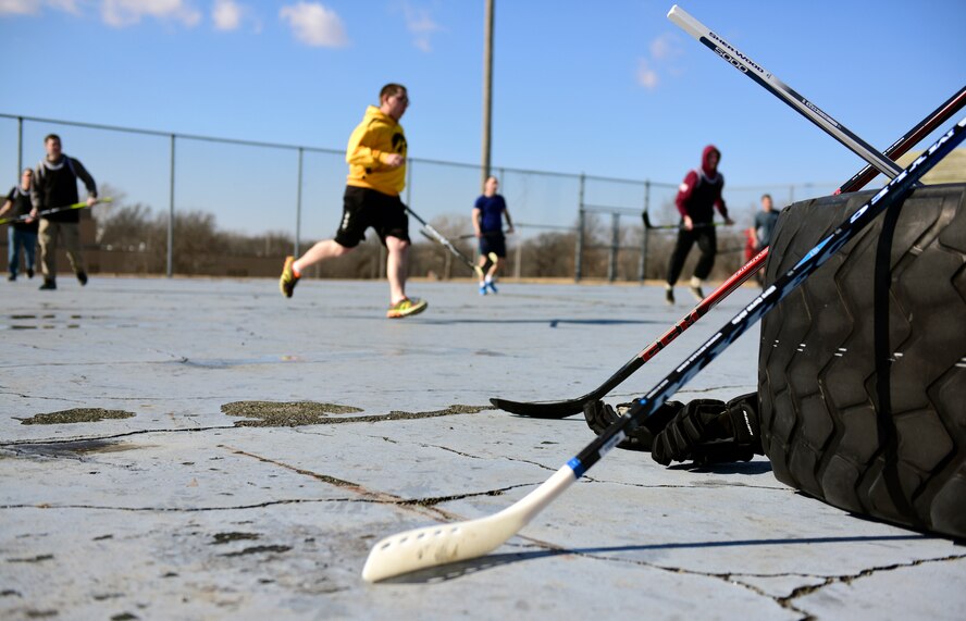 Members of Team Whiteman participate in the first extramural hockey practice at Whiteman Air Force Base, Mo., Feb. 17, 2018. Hockey sticks were available for members who did not have their own gear and jerseys were used to distinguish the teams. (U.S. Air Force photo by Staff Sgt. Danielle Quilla)