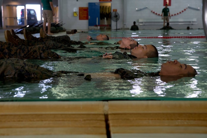 Recruits from Lima Company, 3rd Recruit Training Battalion, float at Marine Corps Recruit Depot San Diego, Feb. 20. The recruits were required to tread water for four minutes to enable them to move on to the next portion of the basic water survival test. Annually, more than 17,000 males recruited from the Western Recruiting Region are trained at MCRD San Diego. Lima Company is scheduled to graduate April 20.