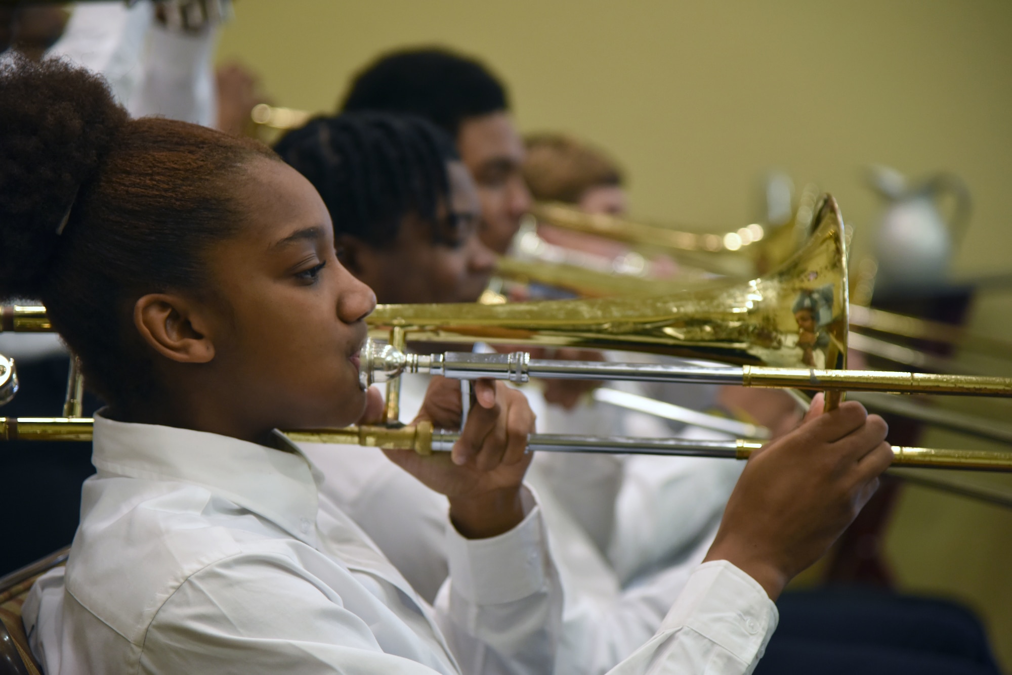 Triniti Cooper, Moss Point High School Jazz Ensemble member, plays the trombone during the African-American Heritage Committee Luncheon at the Bay Breeze Event Center Feb. 20, 2018, on Keesler Air Force Base, Mississippi. The theme of African American History Month this year is “African Americans in Times of War.” Proceeds from the event will benefit the Col. Lawrence E. Roberts memorial scholarship fund which helps local youth pay for tuition, books and other academic costs. Roberts, a Biloxi resident and Tuskegee Airman, passed away in 2004. (U.S. Air Force photo by Kemberly Groue)