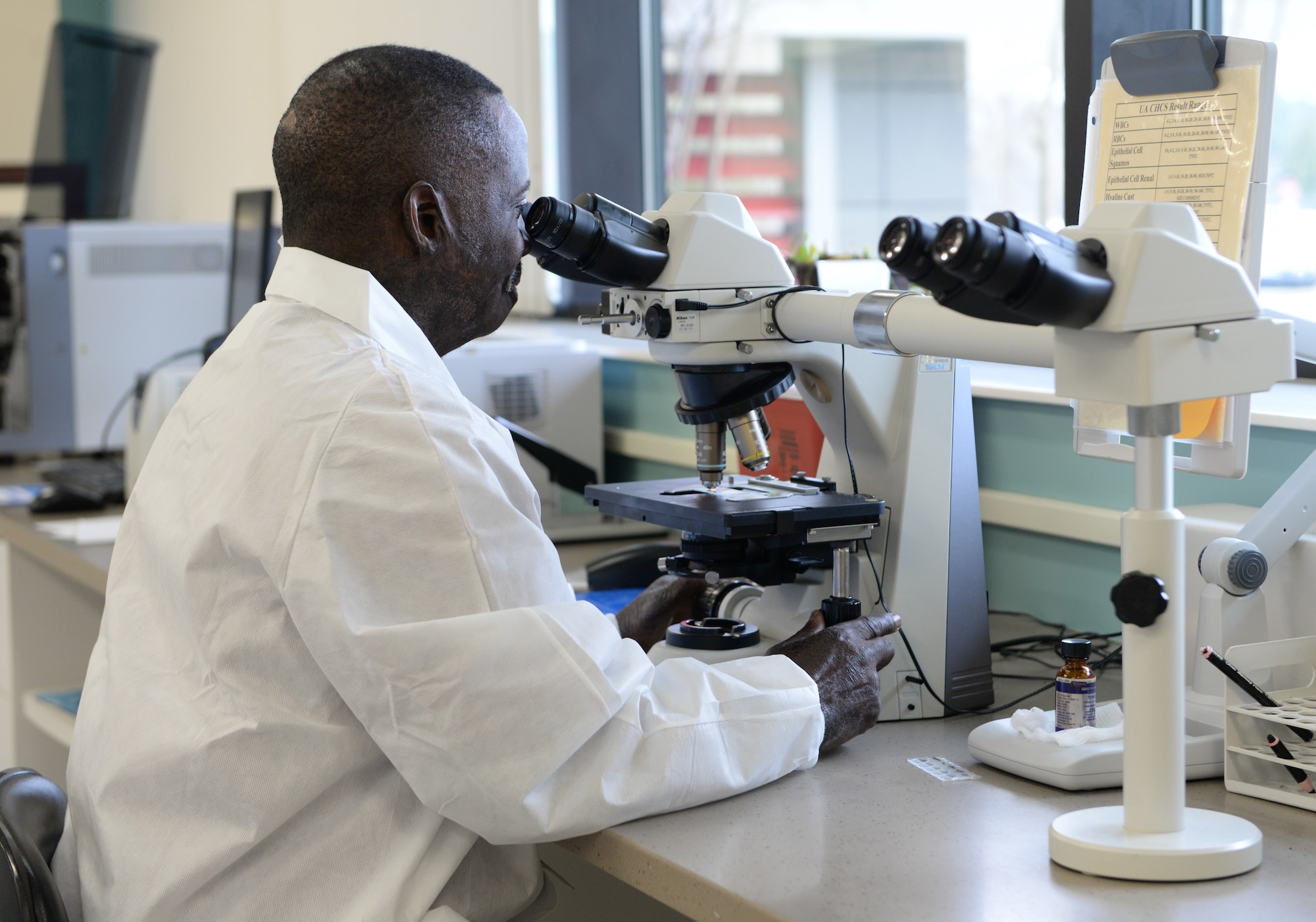 Tony Givens, 14th Medical Support Squadron laboratory services technical supervisor, inspects a test sample Feb. 20, 2018, on Columbus Air Force Base, Mississippi. From August to January no patients have fainted during blood draws, and the lab continues to strive toward minimizing the risk of patients passing out during the blood drawing process. (U.S. Air Force photo by Airman 1st Class Keith Holcomb)