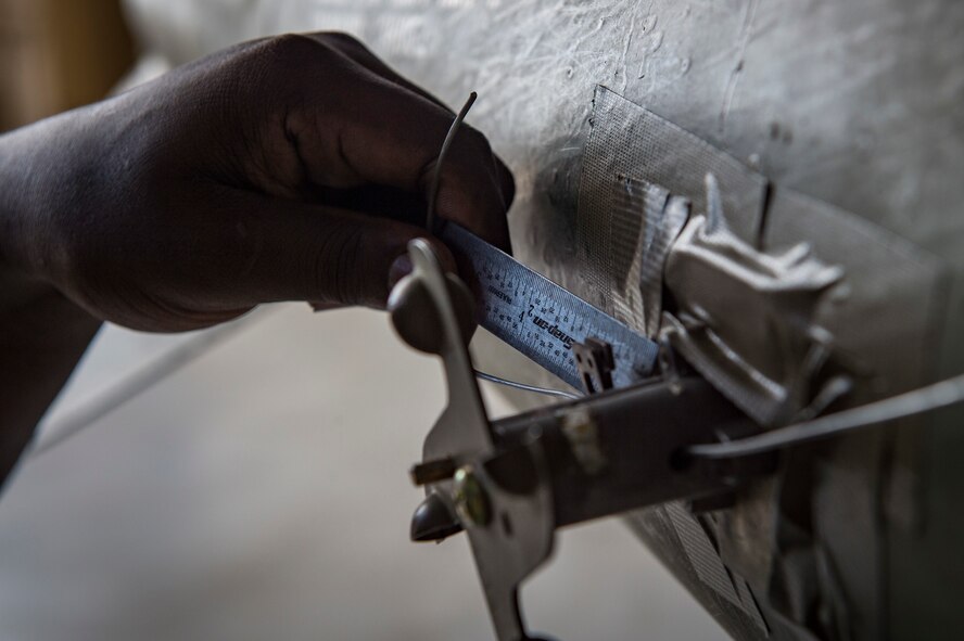 Airman 1st Class Devonta’ Edmonds, 75th Aircraft Maintenance Unit (AMU) weapons load crew chief, measures an umbilical on an inert MK-84 general purpose bomb during a weapons-load competition, Feb. 22, 2018, at Moody Air Force Base, Ga. Judges assessed the 75th and 74th AMUs on how quickly and efficiently they loaded munitions onto an A-10C Thunderbolt II during the loading portion of the competition. They were also judged on dress and appearance and a written test based on munition knowledge. (U.S. Air Force photo by  Senior Airman Janiqua P. Robinson)