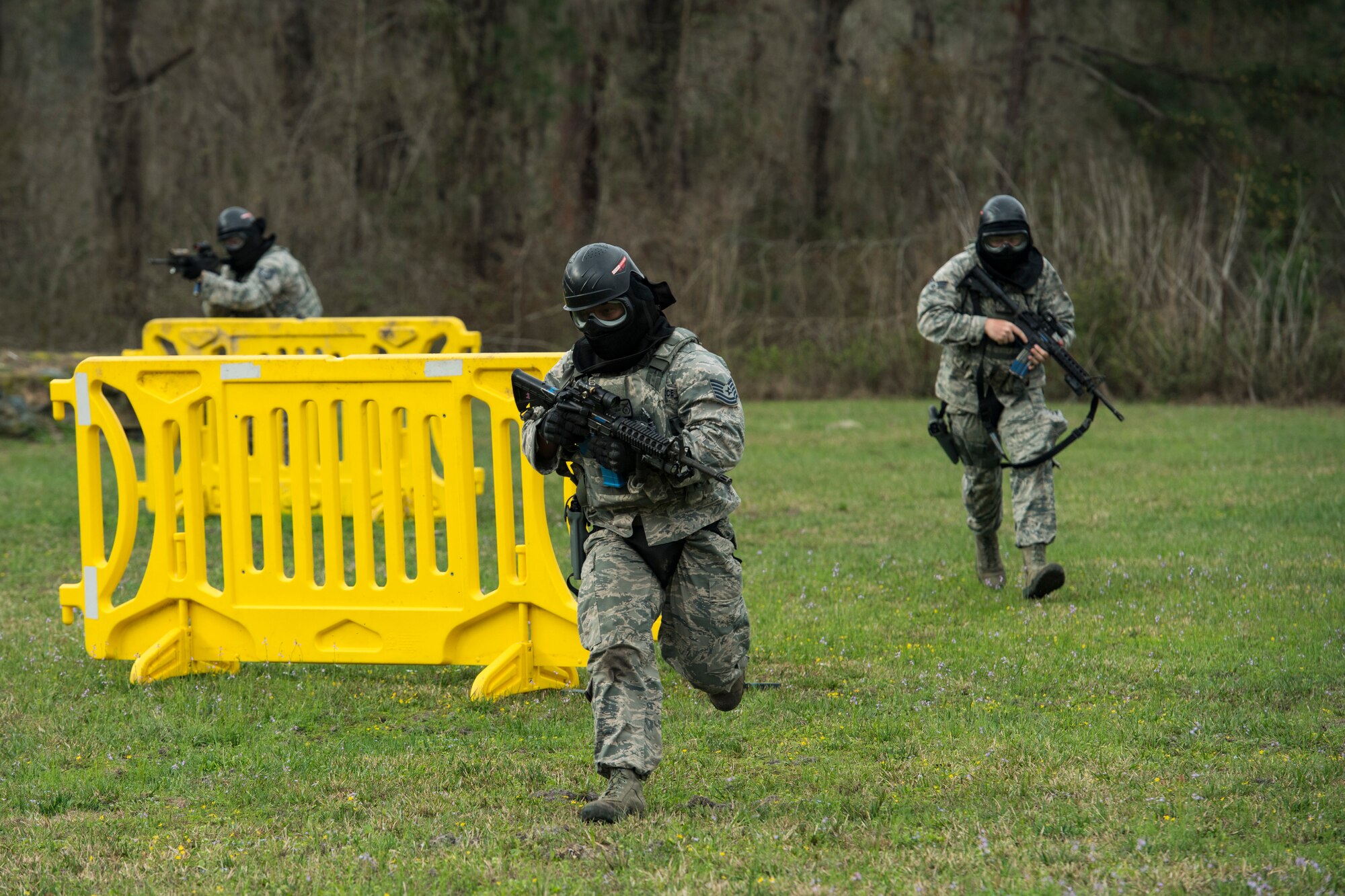 “Shoot, move, communicate” is a training event that tests participants on their ability to move from barricade to barricade as a team. While one member provided covering fire the others advanced on the enemy, then retreated from the scenario while they maintained cover fire. Security Forces members would employ these tactics anytime they’re under enemy fire. (U.S. Air Force photo by Senior Airman Janiqua P. Robinson)