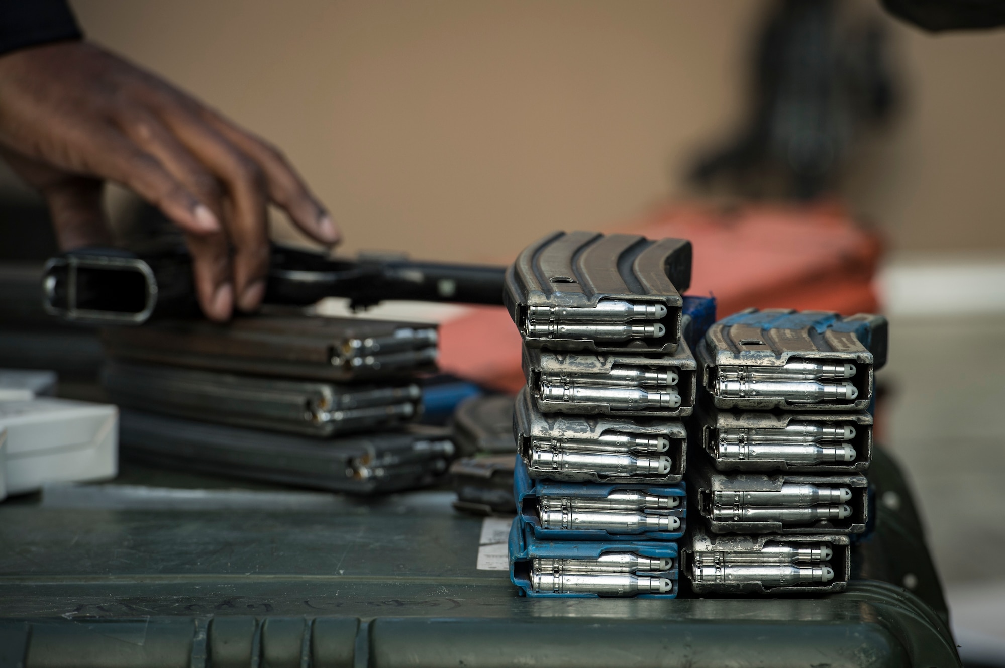 Ammunition magazines rest on a pelican case before a training event, Feb. 22, 2018, at Moody Air Force Base, Ga. “Shoot, move, communicate” is a training event that tests participants on their ability to move from barricade to barricade as a team. While one member provided covering fire the others advanced on the enemy, then retreated from the scenario while they maintained cover fire. Security Forces members would employ these tactics anytime they’re under enemy fire. (U.S. Air Force photo by Senior Airman Janiqua P. Robinson)