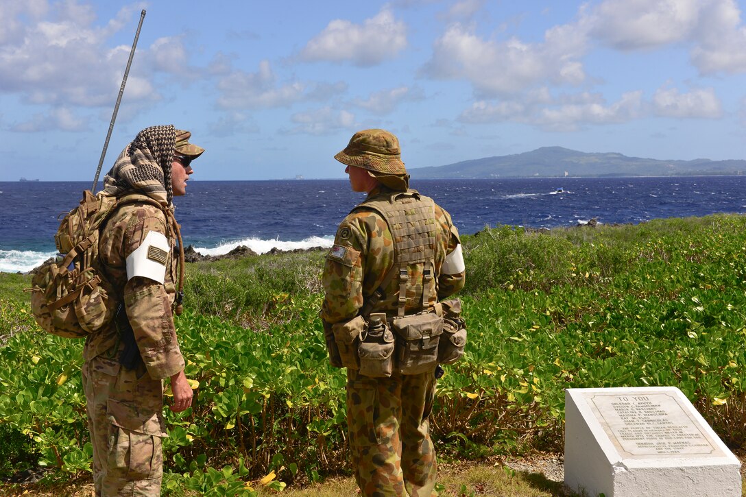 Air Force members from the U.S. and Australia discuss search and rescue medical evacuation training during exercise Cope North 18 in Tinian, Northern Marianas Islands.