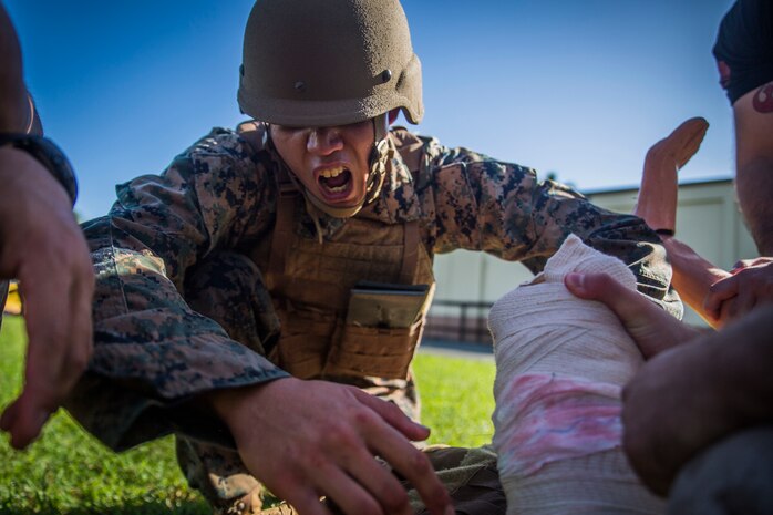 Lance Cpl. Andrew Borja, a maintenance management specialist with Detachment 4th Force Reconnaissance Company, rehearses combat lifesaving techniques during a Tactical Combat Casualty Care (TCCC) exercise, Davie Point, Marine Corps Base Hawaii, Feb. 7, 2018. The TCCC course took advantage of the unique training areas Davie Point has to offer by including an amphibious landing, a combat patrol, and a firefight simulation with paintball guns. (U.S. Marine Corps photo by Lance Cpl. Luke Kuennen)