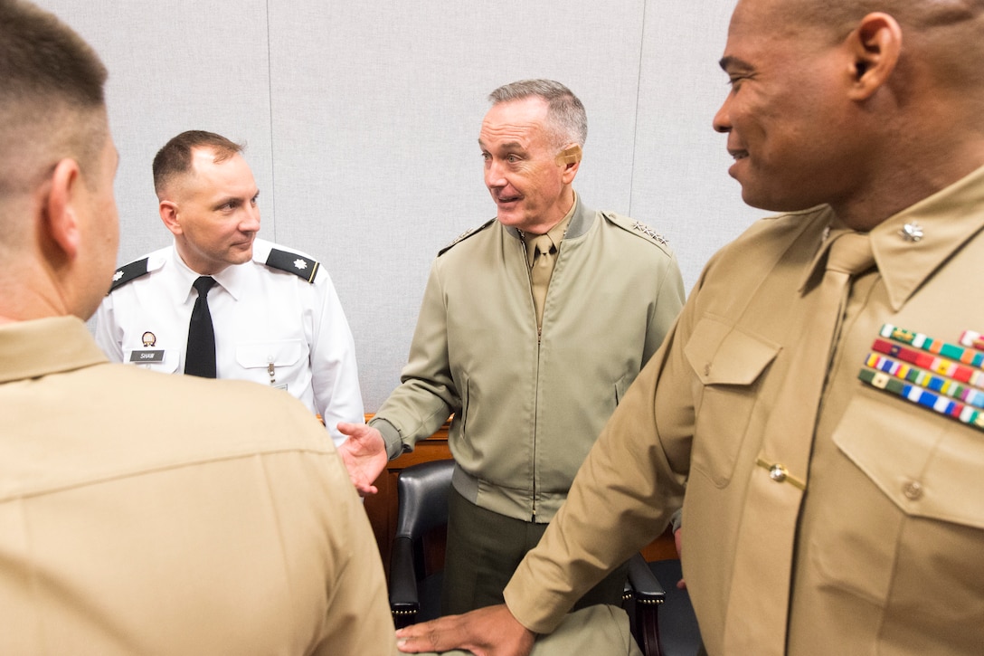Marine Corps Gen. Joe Dunford, chairman of the Joint Chiefs of Staff, talks to three Marines.