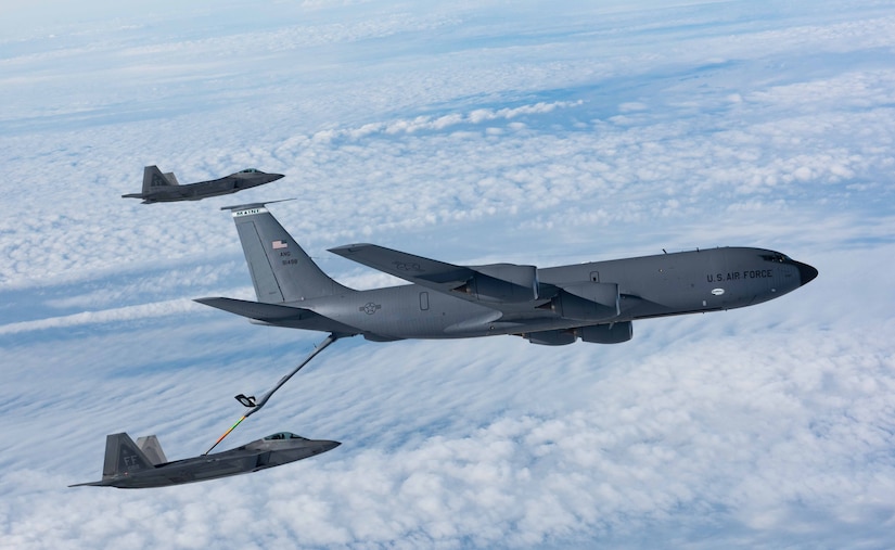 A KC-135 Stratotanker from the 101st Air Refueling Wing refuels F-22 Raptors from the 94th Fighter Squadron over the Atlantic Ocean, Feb. 22, 2018.