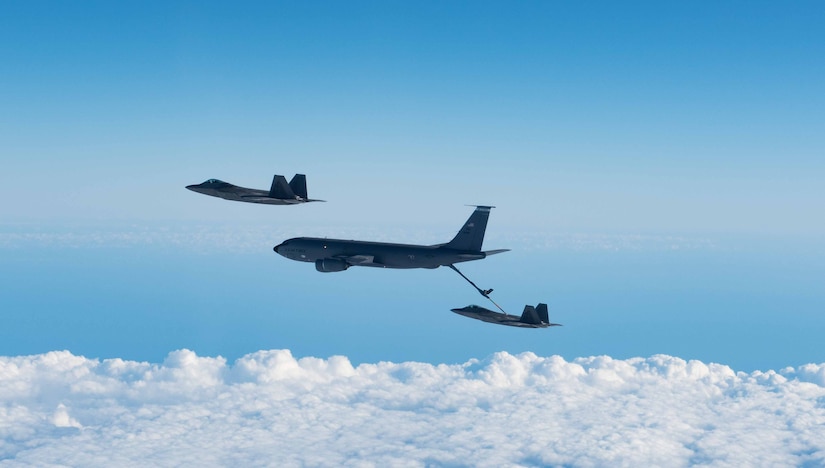 A KC-135 Stratotanker from the 101st Air Refueling Wing refuels F-22 Raptors from the 94th Fighter Squadron over the Atlantic Ocean, February 22, 2018.