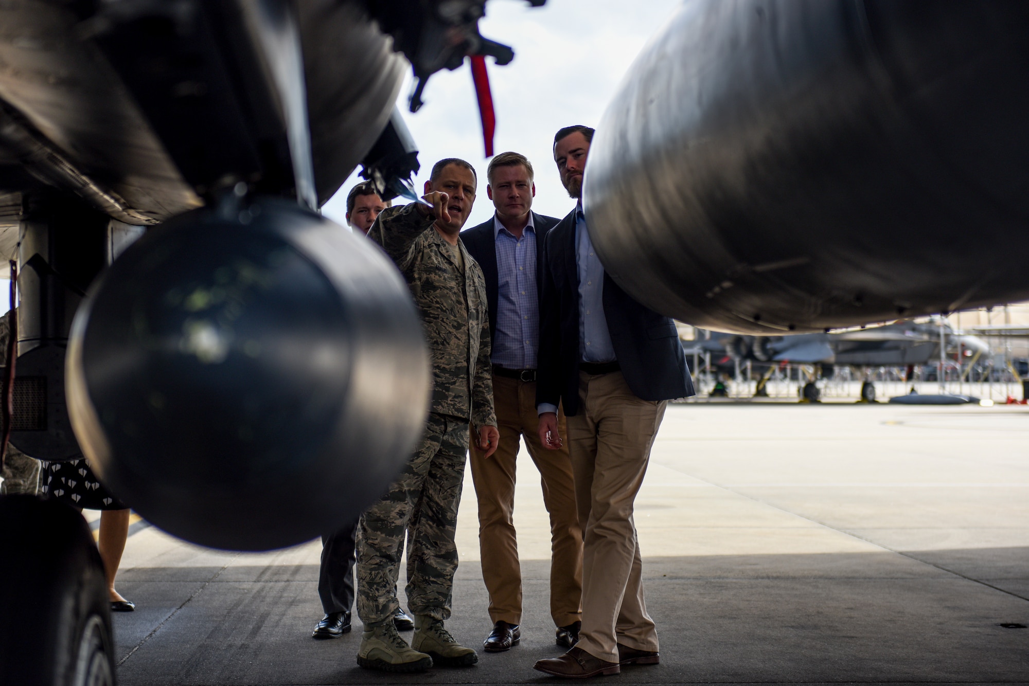 Chief Master Sgt. William Adams, 4th Fighter Wing command chief, explains the capabilities of the F-15E Strike Eagle to Bo Prosch and Cole Lyle, staff delegates from the offices of North Carolina Sens. Thom Tillis and Richard Burr, respectively, during an orientation tour, Feb. 21, 2018, at Seymour Johnson Air Force Base, North Carolina. In addition to getting an up-close view of the aircraft, the representatives were also briefed on the Strike Eagle's mission and tested out its abilities in the training simulators. (U.S. Air Force photo by Staff Sgt. Brittain Crollley)