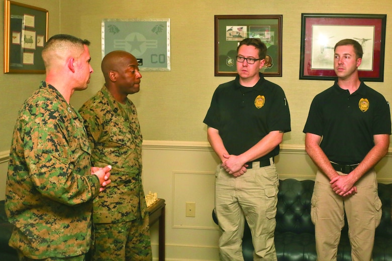 Col. Timothy Miller and Sgt. Maj. Derrick Mays congratulate police officers Sean Sullivan and Peter Bunting aboard Marine Corps Air Station Beaufort Feb. 20. Sullivan and Bunting saved the life of a recruit aboard Marine Corps Recruit Depot Parris Island Feb. 4. Miller is the Commanding Officer and Mays is the Sergeant Major of Marine Corps Air Station Beaufort.