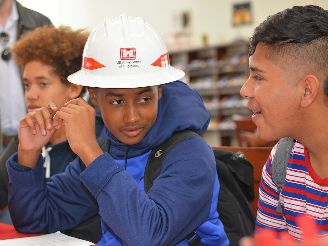 A high school student at John Muir High School in Pasadena, California, tries on a U.S. Army Corps of Engineers hardhat during the school’s Engineering and Environmental Science Academy School Exploration Showcase Feb. 14 in Pasadena.