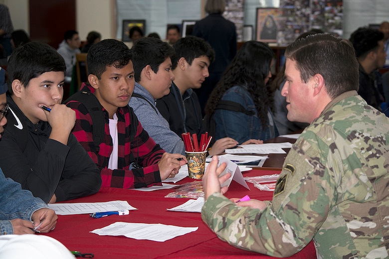 Capt. David Watts, LA District, right, answers questions from students about his career in engineering and as an active-duty Soldier during the Engineering and Environmental Science Academy Career Exploration Showcase Feb. 14 at the John Muir High School in Pasadena, California.