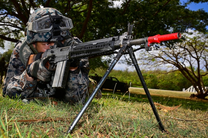 A Japan Air Self-Defense Force member protects a perimeter during search and rescue  medical evacuation operations training during exercise Cope North 18 in Tinian, Northern Marianas Islands.