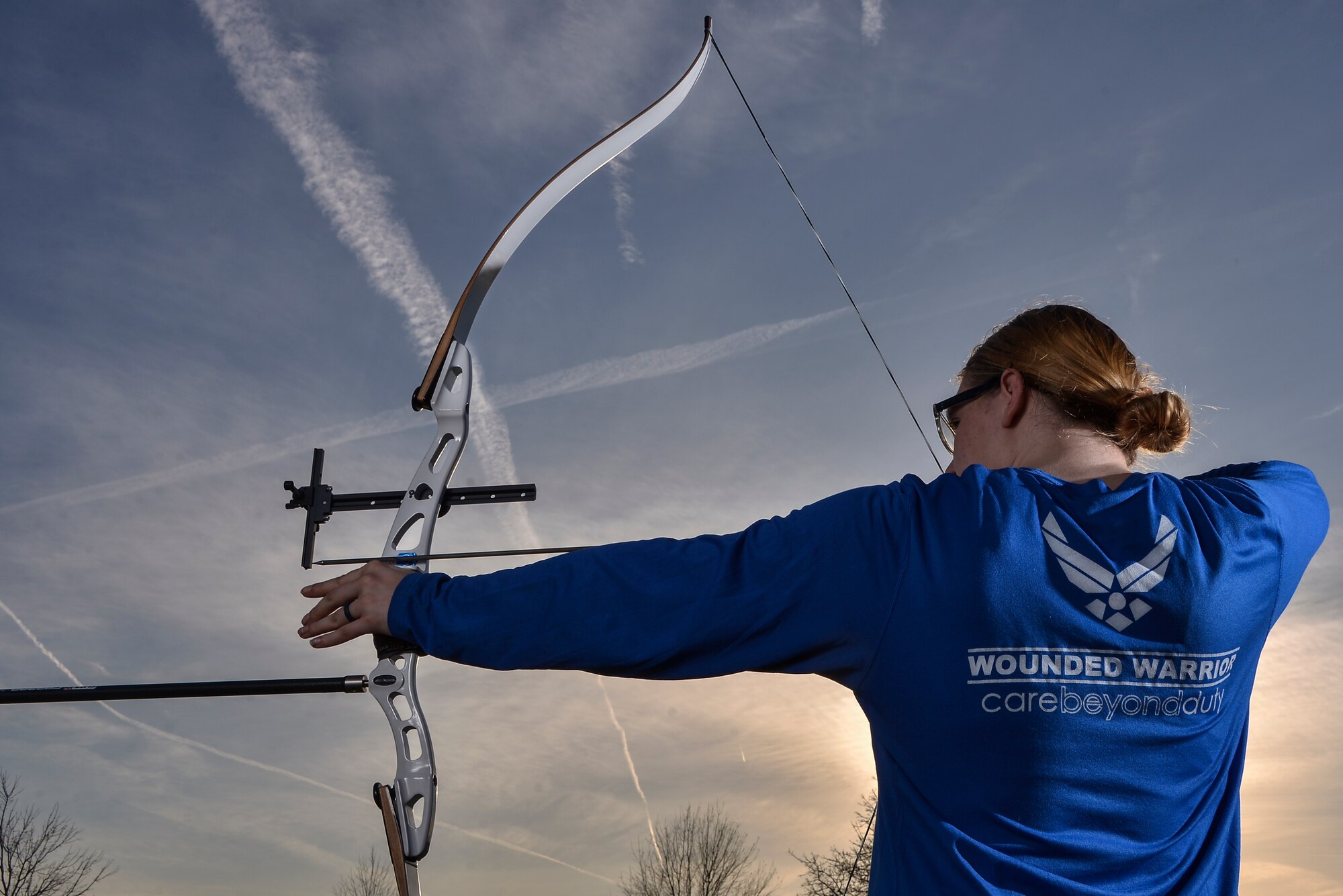 Senior Airman Karah Behrend, Air Force Wounded Warrior, poses for a portrait with her recurve bow that she practices with at Fort George G. Meade, Md., Feb. 7, 2018. Behrend was diagnosed with Reflex Sympathetic Dystrophy (RSD) in 2015. She became an Air Force Wounded Warrior in 2016 and is competing in the 2018 Wounded Warriors team trial for the Air Force. (U.S. Air Force by Staff Sgt. Alexandre Montes)