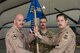 Col. William Marshall, commander of the 332d Expeditionary Operations Group, takes the guidon from Lt. Col. Douglas Olson, outgoing commander of the 361st Expeditionary Attack Squadron during a change of command ceremony February 22, 2018. The 361 EATKS operates and maintains remotely piloted aircraft in support of Operation Inherent Resolve. (U.S. Air Force photo by Staff Sgt. Joshua Kleinholz)
