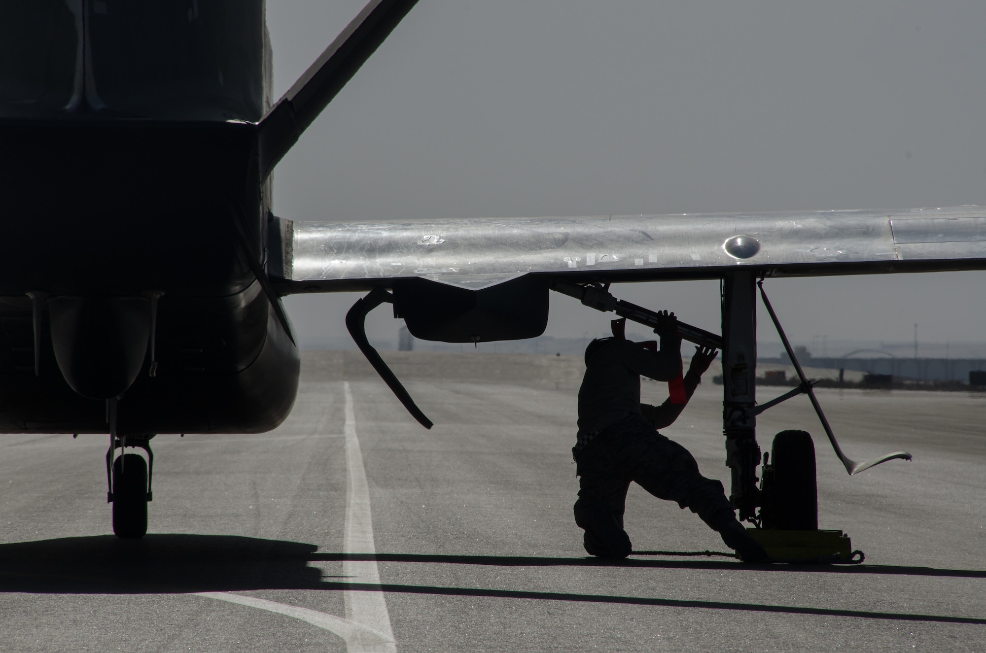 U.S. Air Force Senior Airman Dakota McAfee assigned to the 99th Expeditionary Reconnaissance Squadron, RQ-4 avionics technician, recovers an RQ-4 Global Hawk Feb. 13, 2018 at Al Dhafra Air Base, United Arab Emirates. The Global Hawk has been deployed operationally to support overseas contingency operations since November 2001. (U.S. Air National Guard photo by Staff Sgt. Colton Elliott)