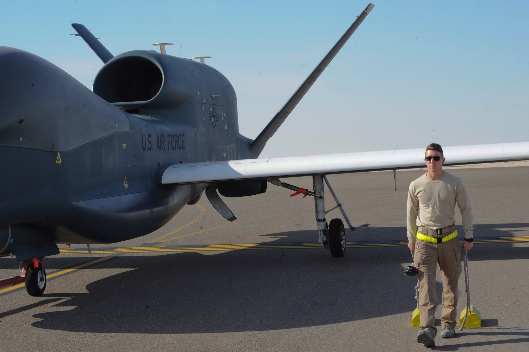 U.S. Air Force Senior Airman Dakota McAfee assigned to the 99th Expeditionary Reconnaissance Squadron, RQ-4 avionics specialist, recovers an RQ-4 Global Hawk Feb. 13, 2018 at Al Dhafra Air Base, United Arab Emirates. The Global Hawk has been deployed operationally to support overseas contingency operations since November 2001. (U.S. Air Force photo by Airman 1st Class D. Blake Browning)