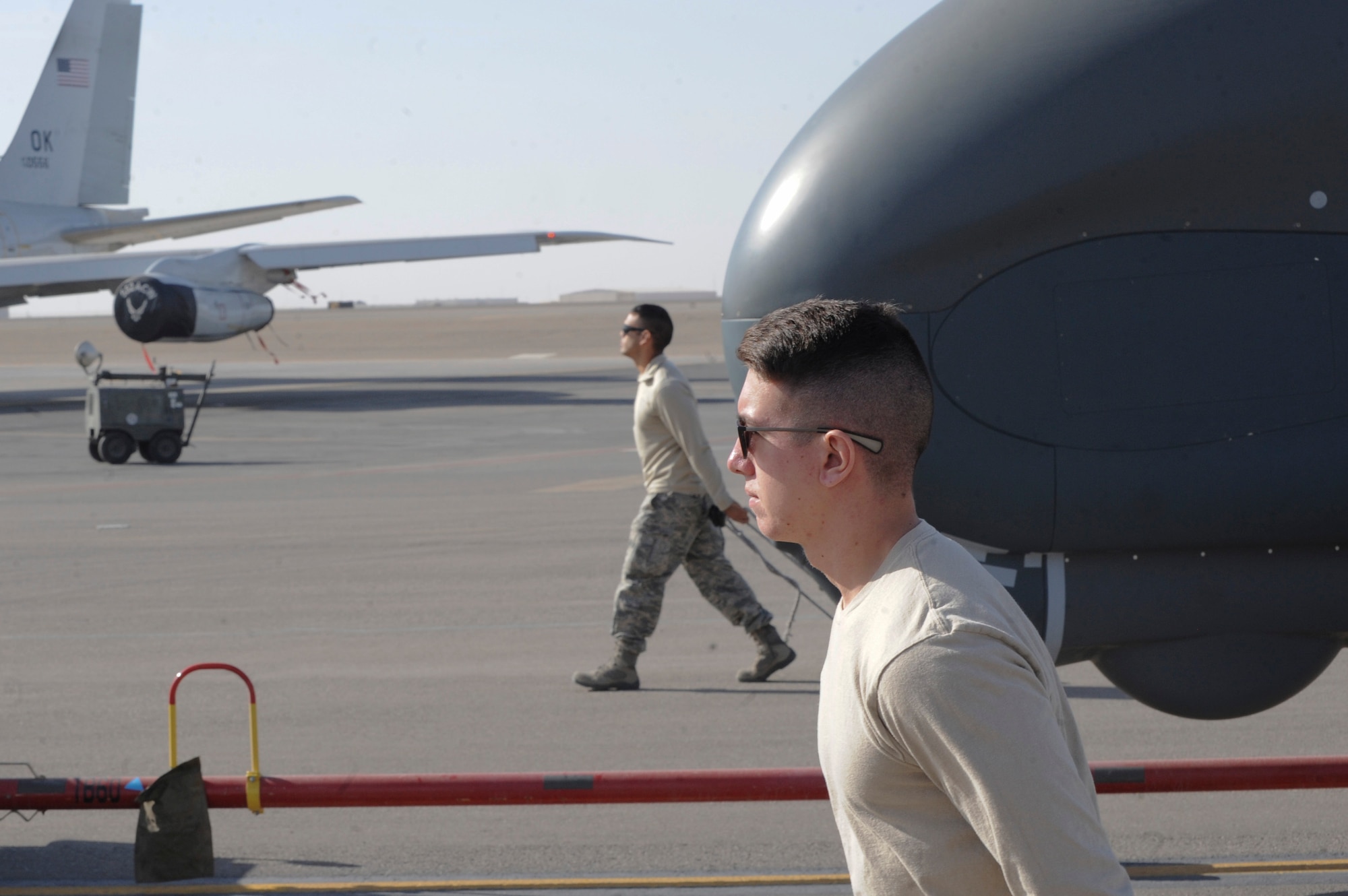 U.S. Air Force Senior Airman Dakota McAfee and Senior Airman Christopher Asbury assigned to the 99th Expeditionary Reconnaissance Squadron, RQ-4 avionics technicians, recovers an RQ-4 Global Hawk Feb. 13, 2018 at Al Dhafra Air Base, United Arab Emirates. The Global Hawk has been deployed operationally to support overseas contingency operations since November 2001. (U.S. Air Force photo by Airman 1st Class D. Blake Browning)