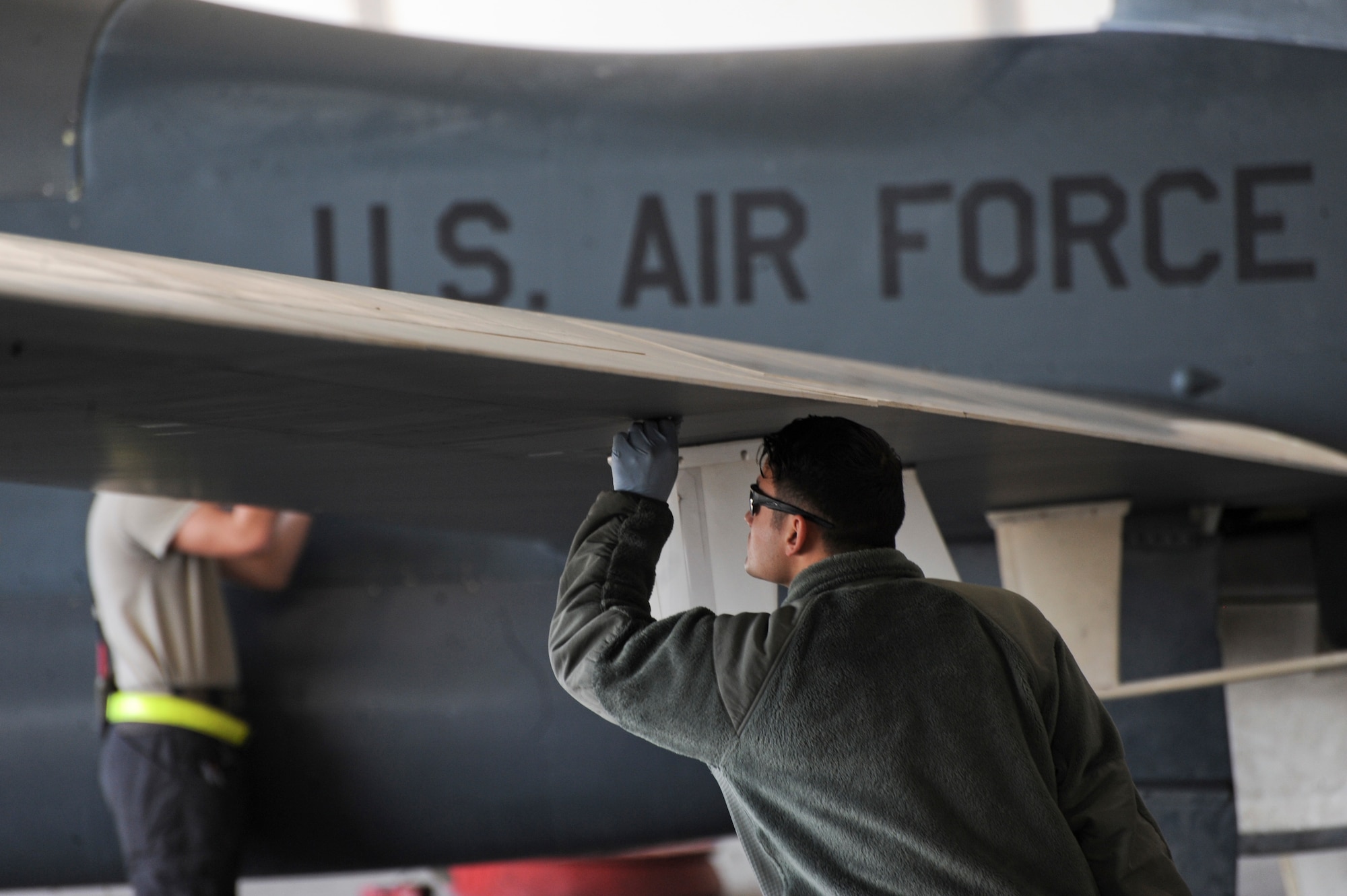 U.S. Air Force Airman 1st Class Christian De Jesus Roman, 380th Expeditionary Aircraft Maintenance Squadron crew chief, conducts post and preflight inspections on an RQ-4 Global Hawk Feb. 13, 2018 on Al Dhafra Air Base. The RQ-4 Global Hawk is a high-altitude, long-endurance, remotely piloted aircraft with an integrated sensor suite that provides global all-weather, day or night intelligence, surveillance and reconnaissance (ISR) capability. (U.S. Air Force photo by Airman 1st Class D. Blake Browning)