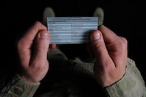 U.S. Air Force Senior Airman Daniel Ray, 380th Security Forces Squadron force protection escort, reads a card identifying Personally Identifiable Information on Al Dhafra Air Base, United Arab Emirates, Feb. 22, 2018. As of Feb 6, 2018, Air Force officials announced a new method in preventing personally identifiable information breaches via email transmissions. (United States Air Force photo by Airman 1st Class D. Blake Browning)