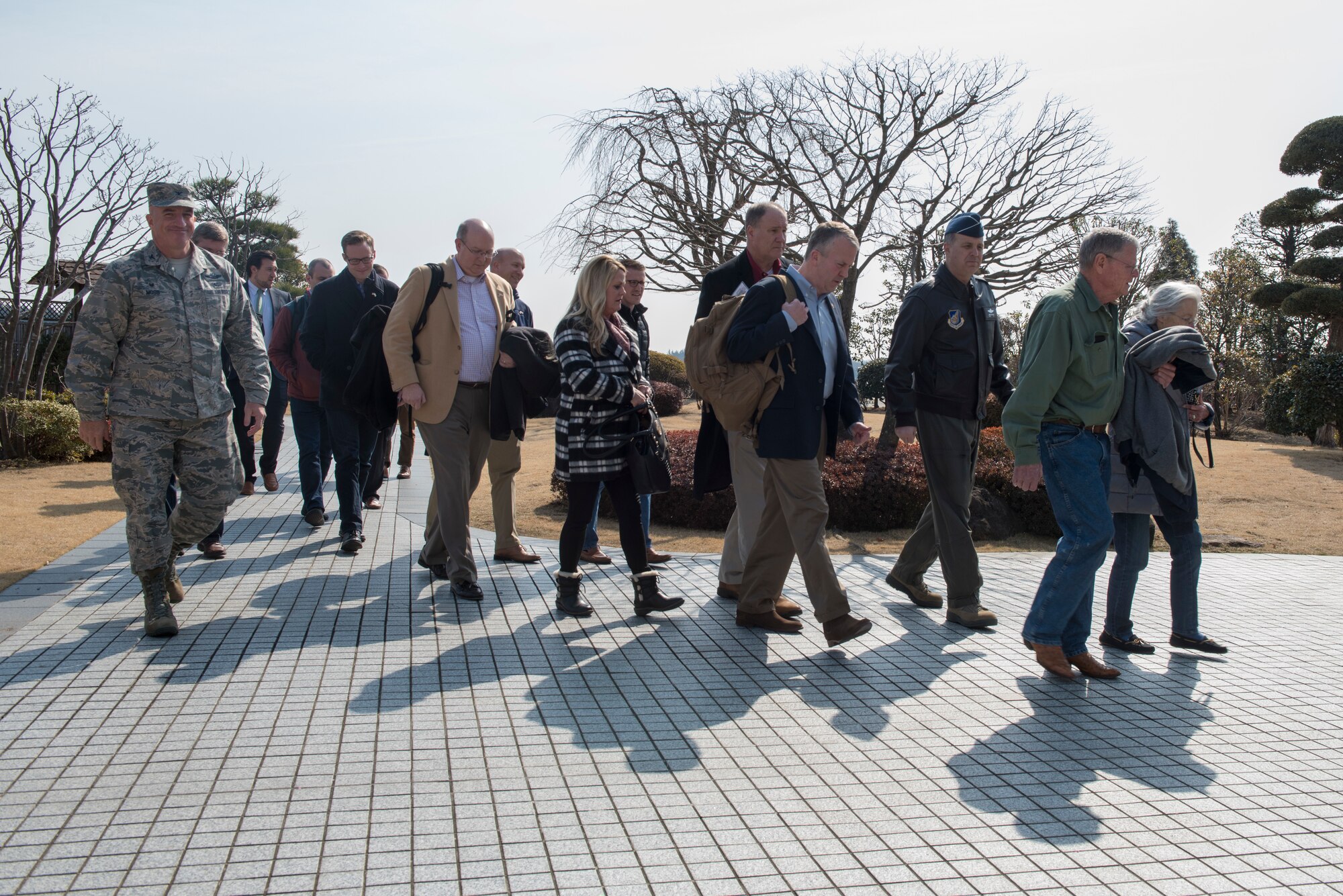 Lt. Gen. Jerry P. Martinez, United States Forces Japan and 5th Air Force commander, and Col. Kenneth E. Moss, 374th Airlift Wing commander, walk with the congressional delegation of Sen. James Inhofe, R-O.K., after their arrival at Yokota Air Base, Japan, Feb. 24, 2018.