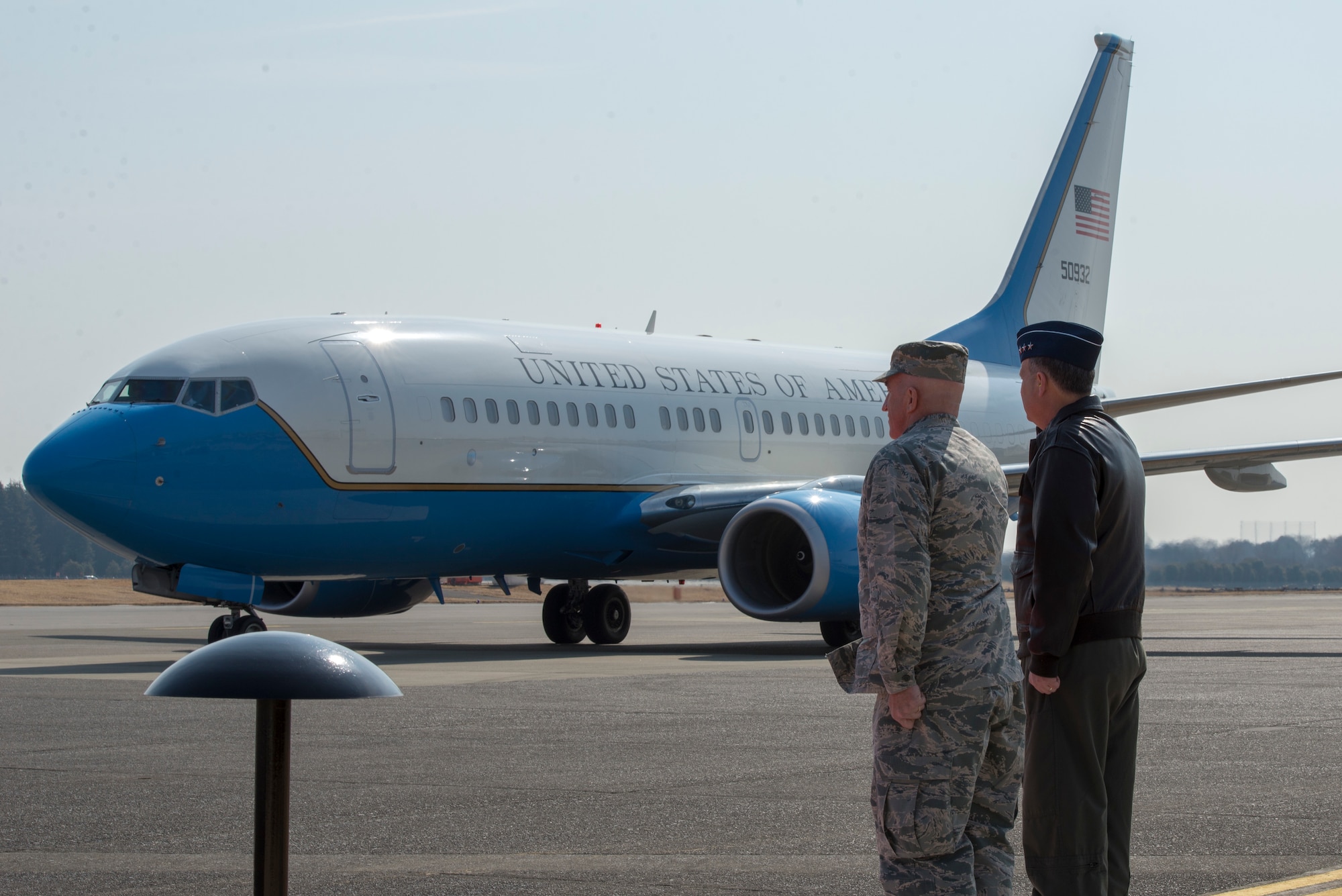 Lt. Gen. Jerry P. Martinez, United States Forces Japan and 5th Air Force commander, and Col. Kenneth E. Moss, 374th Airlift Wing commander, salute the arrival of the congressional delegation of Sen. James Inhofe, R-O.K., at Yokota Air Base, Japan, Feb. 24, 2018.
