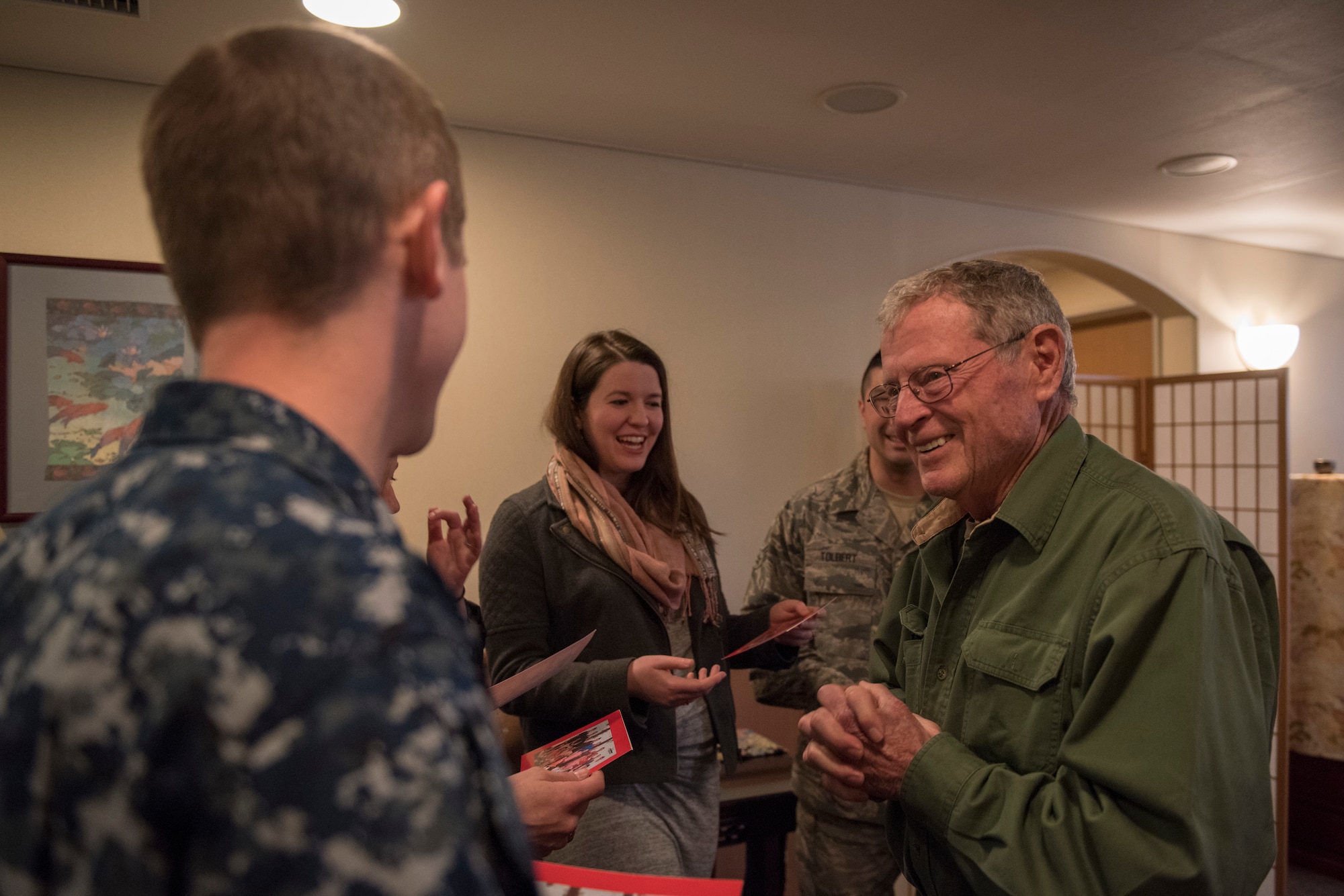 Sen. James Inhofe, R-O.K., shares cards with service members from Oklahoma during a meet and greet at Yokota Air Base, Japan, Feb. 25, 2018.