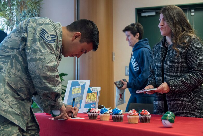 Tech. Sgt. Armando Avalos, 374th Force Support Squadron dining facility shift lead, takes the Saver’s Pledge as part of the Military Saves campaign at Yokota Air Base, Japan, Feb. 26, 2018.