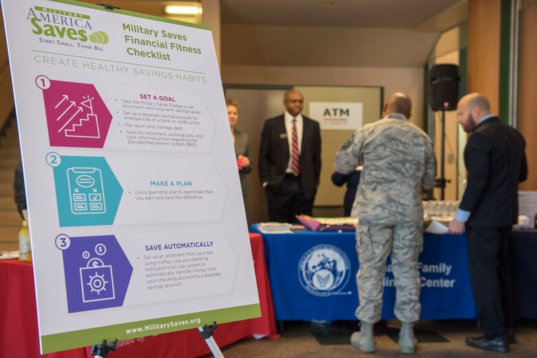 Airman & Family Readiness Center staff assist an Airman in taking the Saver’s Pledge as part of the Military Saves campaign at Yokota Air Base, Japan, Feb. 26, 2018.