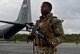 A U.S. Air Force security forces member protects an C-130J Super Hercules during a training scenario at exercise COPE NORTH 18 on Tinian, U.S. Commonwealth of the Northern Marianas Islands, Feb. 20. COPE NORTH enables U.S. and allied forces to train humanitarian assistance/disaster relief operations from austere operating bases, enhancing our capacity and capability to respond in times of crisis. (U.S. Air Force photo by Airman 1st Class Christopher Quail)
