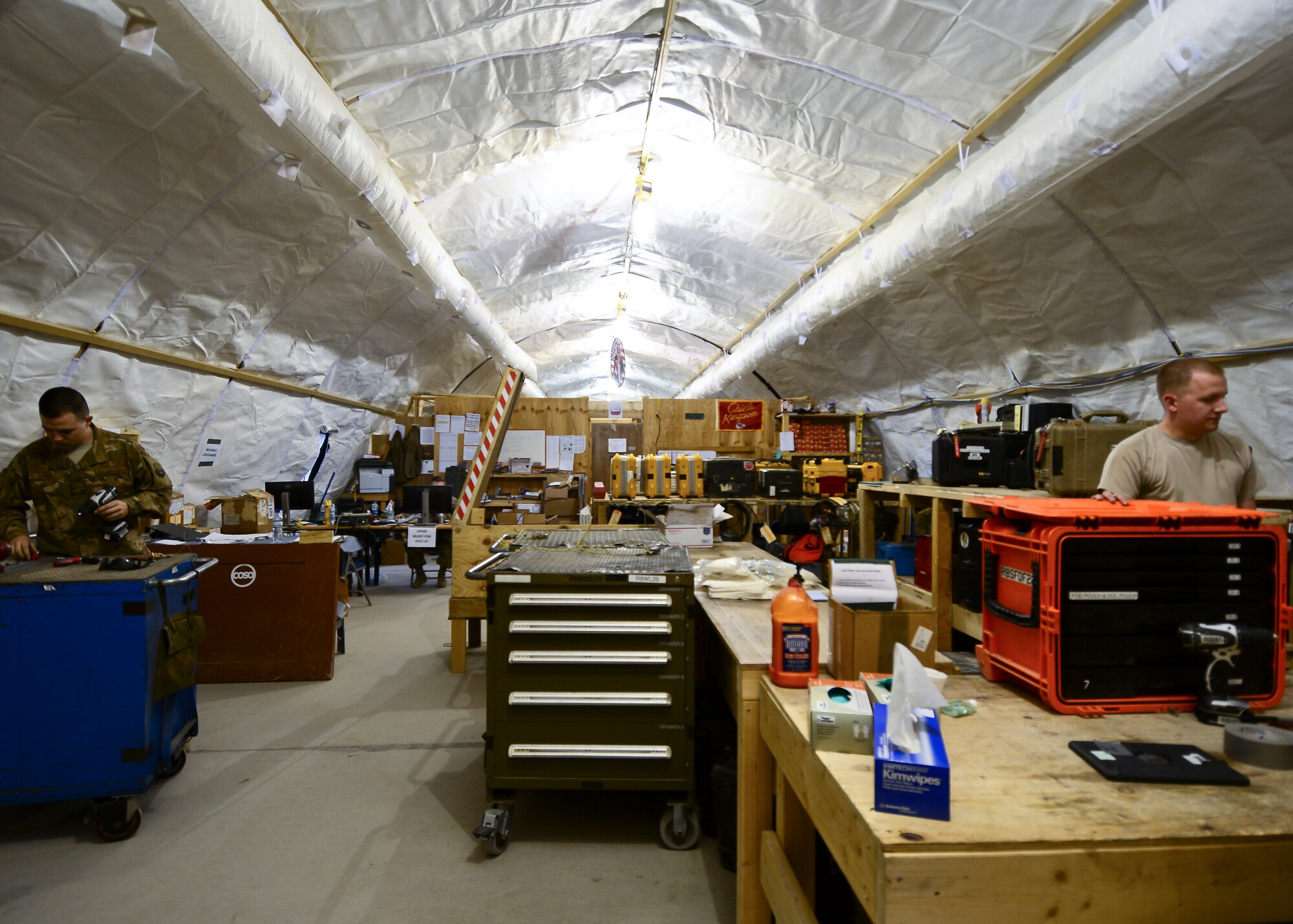 Airmen assigned to the 303rd Expeditionary Fighter Squadron aircraft maintenance unit work in one of the tents coordinated for set-up by the 451st Expeditionary Operations Support Squadron at Kandahar Airfield, Afghanistan Feb. 22, 2018.