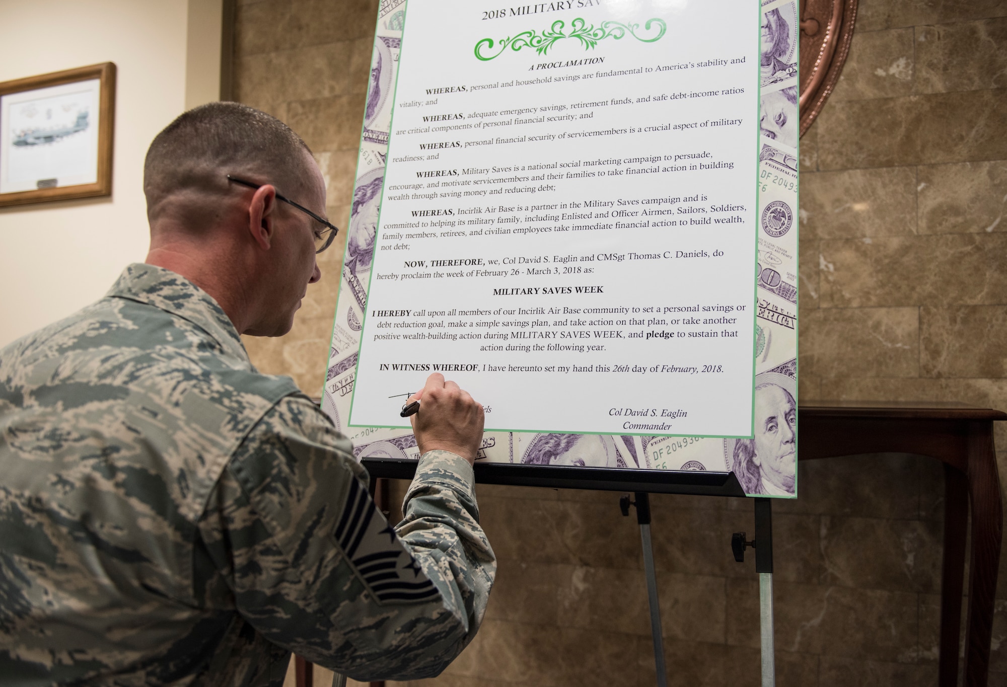 U.S. Air Force Chief Master Sgt. Thomas Daniels, 39th Air Base Wing command chief, signs the Military Saves Week proclamation