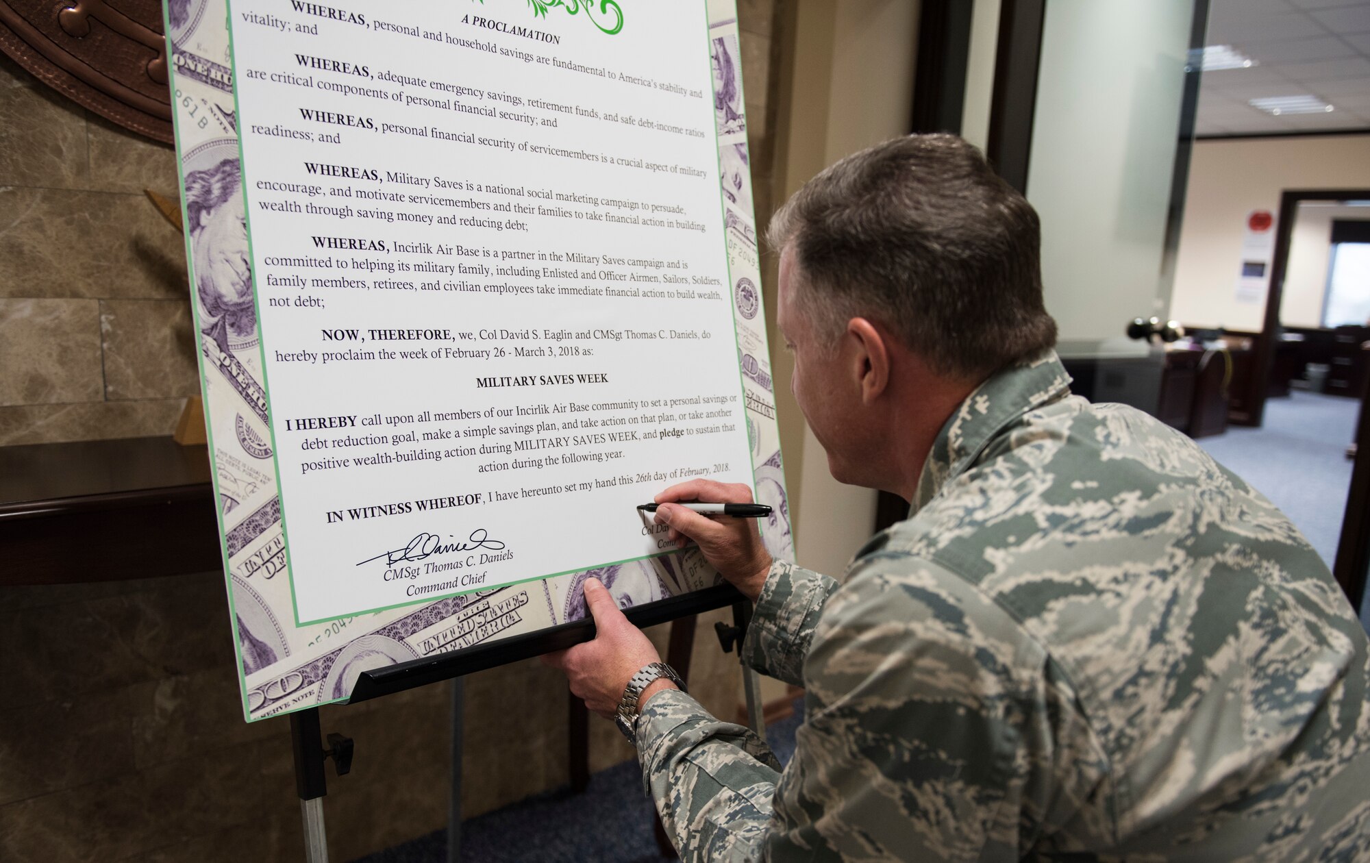 U.S. Air Force Col. David Eaglin, 39th Air Base Wing commander, signs the Military Saves Week proclamation