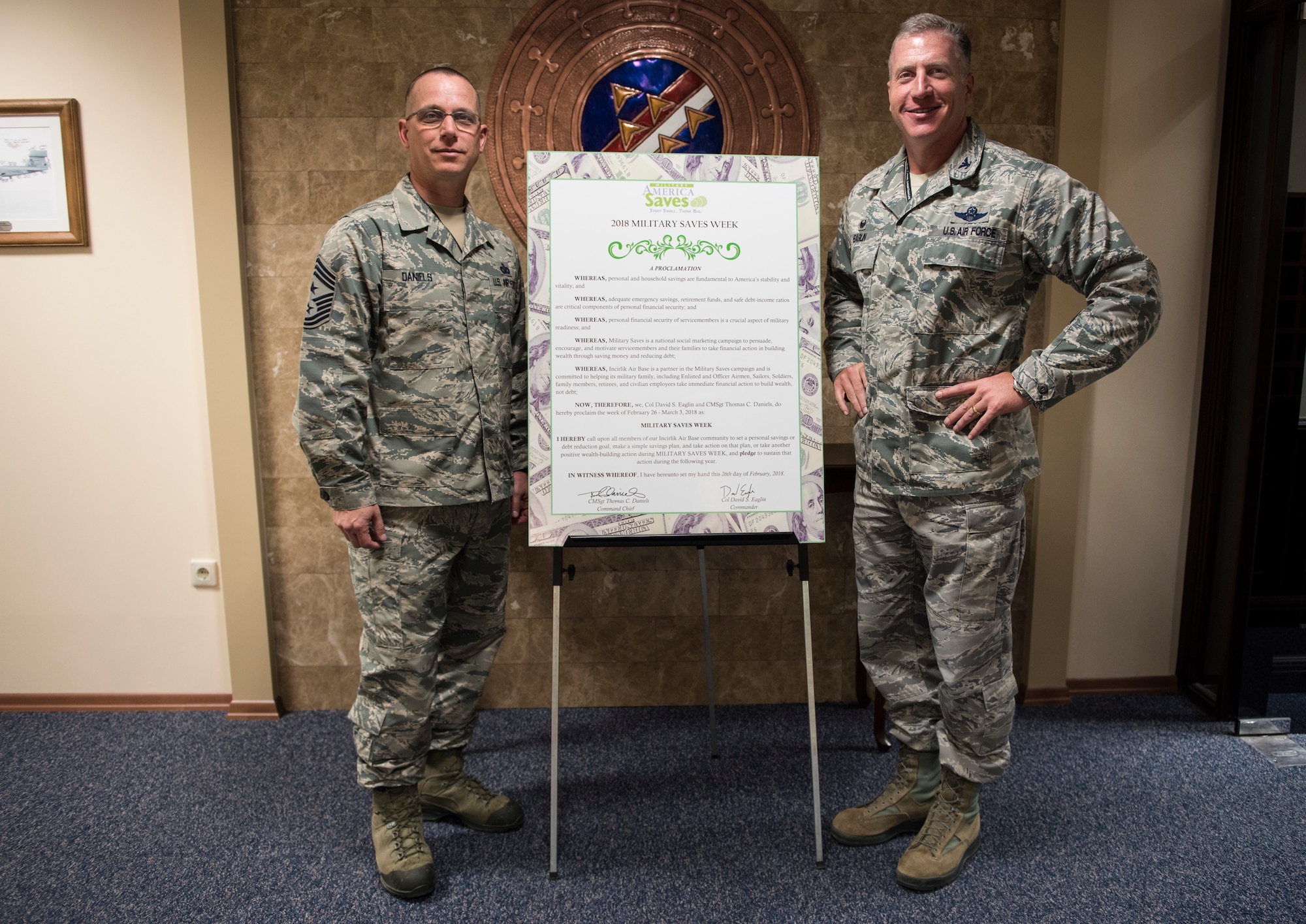 U.S. Air Force Chief Master Sgt. Thomas Daniels, 39th Air Base Wing command chief, and U.S. Air Force Col. David Eaglin, 39th ABW commander, pose with the signed Military Saves Week proclamatio
