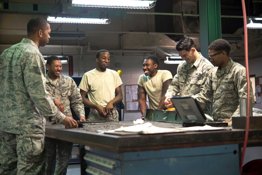 Air Force airmen discuss the afternoon workload at Kadena Air Base.