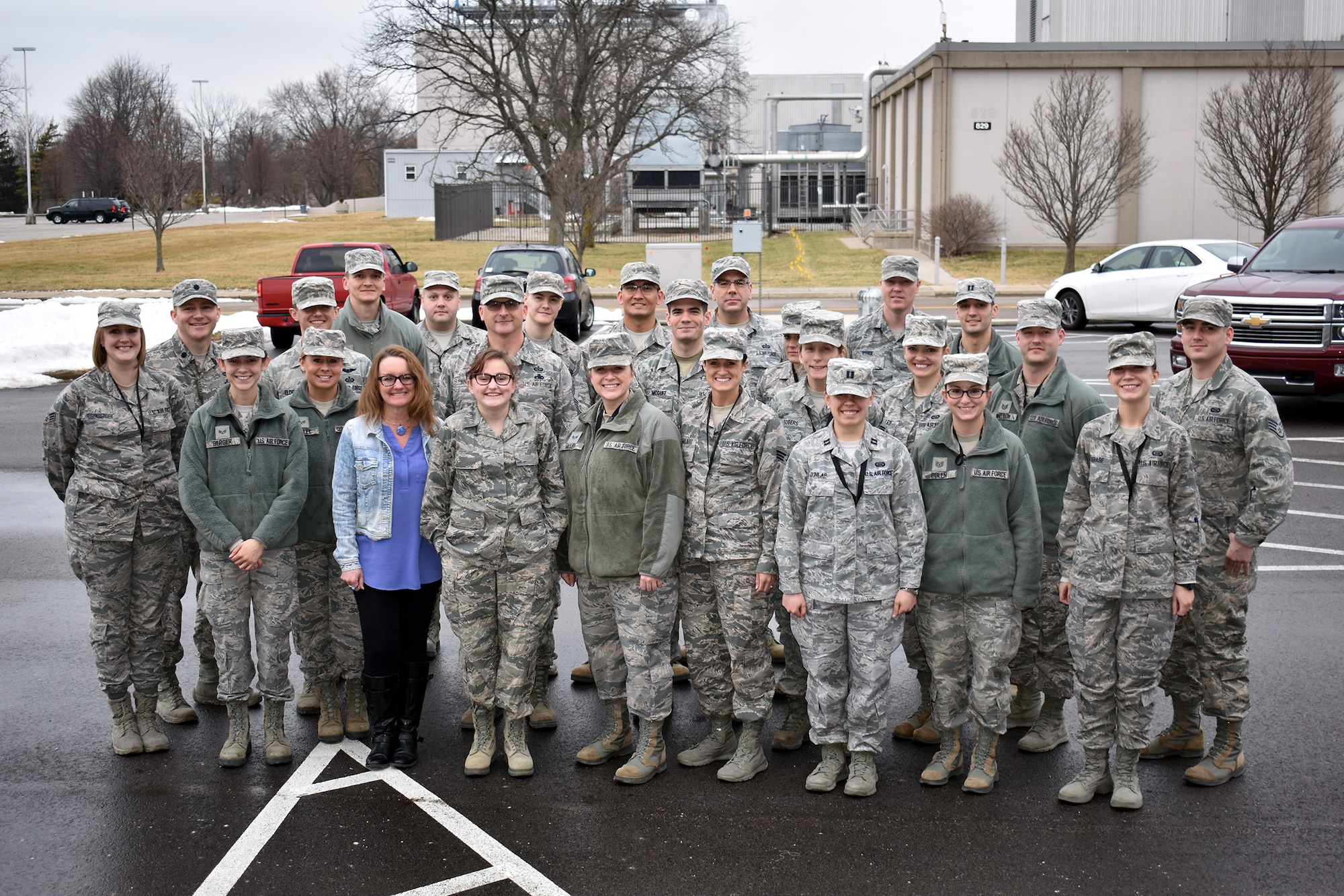 Members of the 655th Intelligence, Surveillance and Reconnaissance Group’s 71st Intelligence Squadron pose with honorary squadron member Tori and her mother Shelley, during the Jan. 21, 2018 unit training assembly here