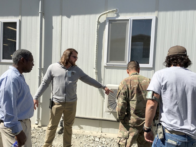 Andrew Brand, second from left, project manager with Task Force POWER, Afghanistan, leads a pre-opening inspection of a new Dining Facility at Camp Oqab, Afghanistan, in September. Brand is deployed there on behalf of Ordnance and Explosives Design Center’s Global Operations Division.