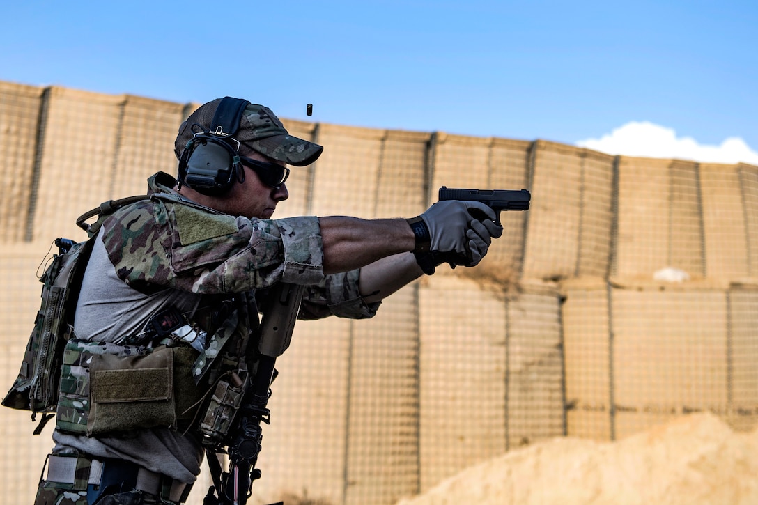 An Air Force pararescueman fires his Glock 9mm handgun during close range weapons training.