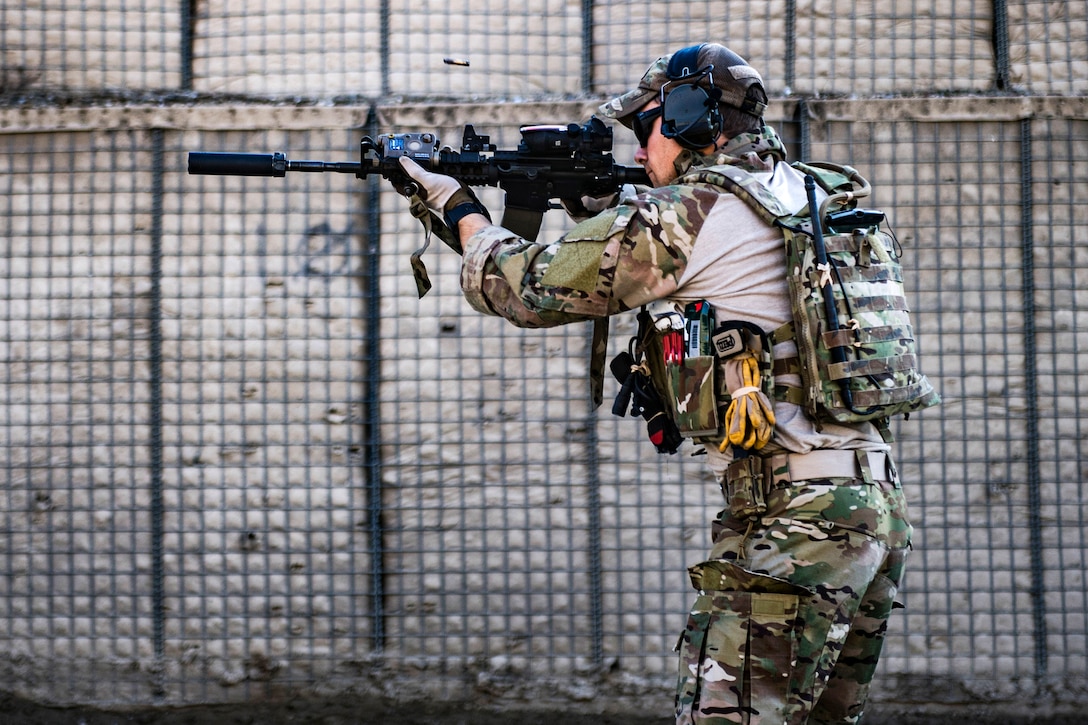 An Air Force airman zeros his weapon using a silencer before conducting weapons training.