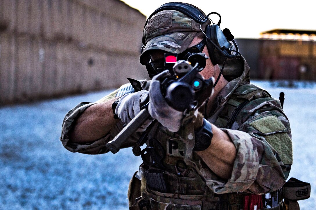 An Air Force pararescueman aims his rifle on his targets during close range weapons training.