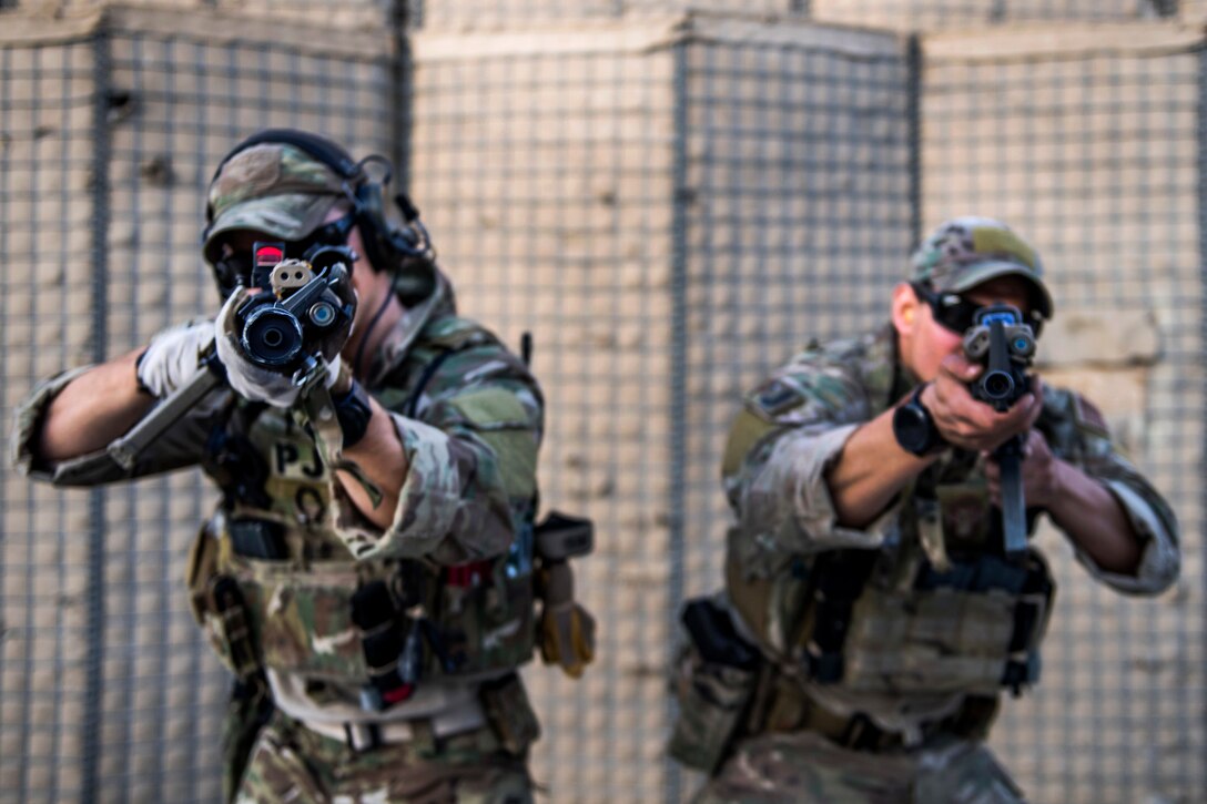 Air Force pararescuemen take aim with their rifles at targets during close range weapons training.