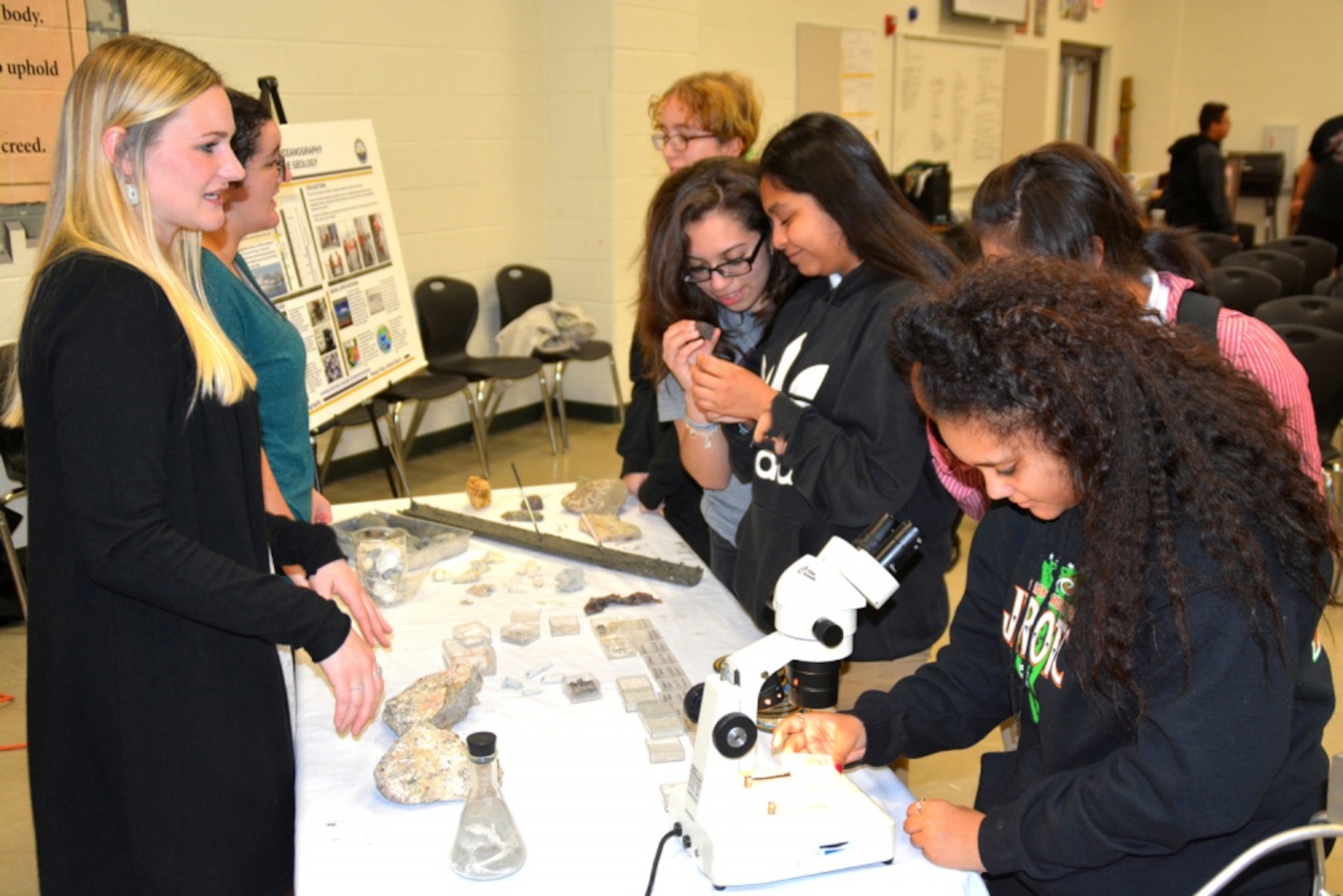 Civilian personnel assigned to the Naval Meteorology and Oceanography Command, or NMOC, headquartered at the John C. Stennis Space Center in Mississippi speak with students of Sam Houston High School during Navy Week San Antonio, Feb. 19-25. The NMOC provides environmental information to help naval and joint forces operate more safely and effectively, and make better decisions faster than the adversary. Every year, America's Navy comes home to approximately 15 cities across the country to show Americans why having a strong Navy is critical to the American way of life.