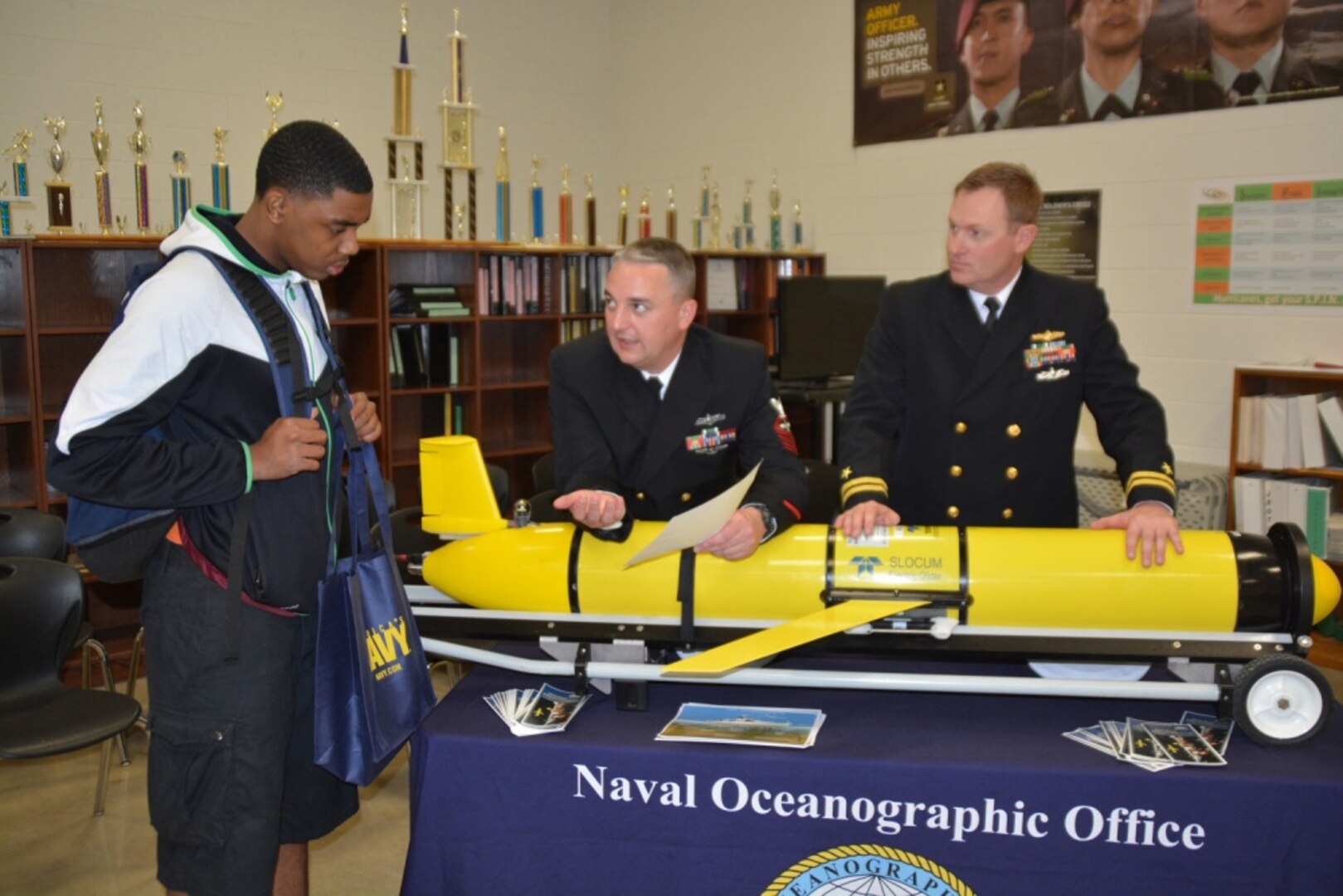 Chief Aerographer™s Mate Jason Archibald of Tulsa, Okla., and Lt. Justin Shaw of Sacramento, Calif., both assigned to the Naval Oceanographic Office, Naval Meteorology and Oceanography Command (NMOC) headquartered at the John C. Stennis Space Center in Mississippi speak with Jalen Watkins, a junior attending Sam Houston High School, about the Science, Mathematics, and Research for Transformation Scholarship Program during Navy Week San Antonio, Feb. 19-25. The NMOC provides environmental information to help naval and joint forces operate more safely and effectively, and make better decisions faster than the adversary. Every year, America's Navy comes home to approximately 15 cities across the country to show Americans why having a strong Navy is critical to the American way of life.