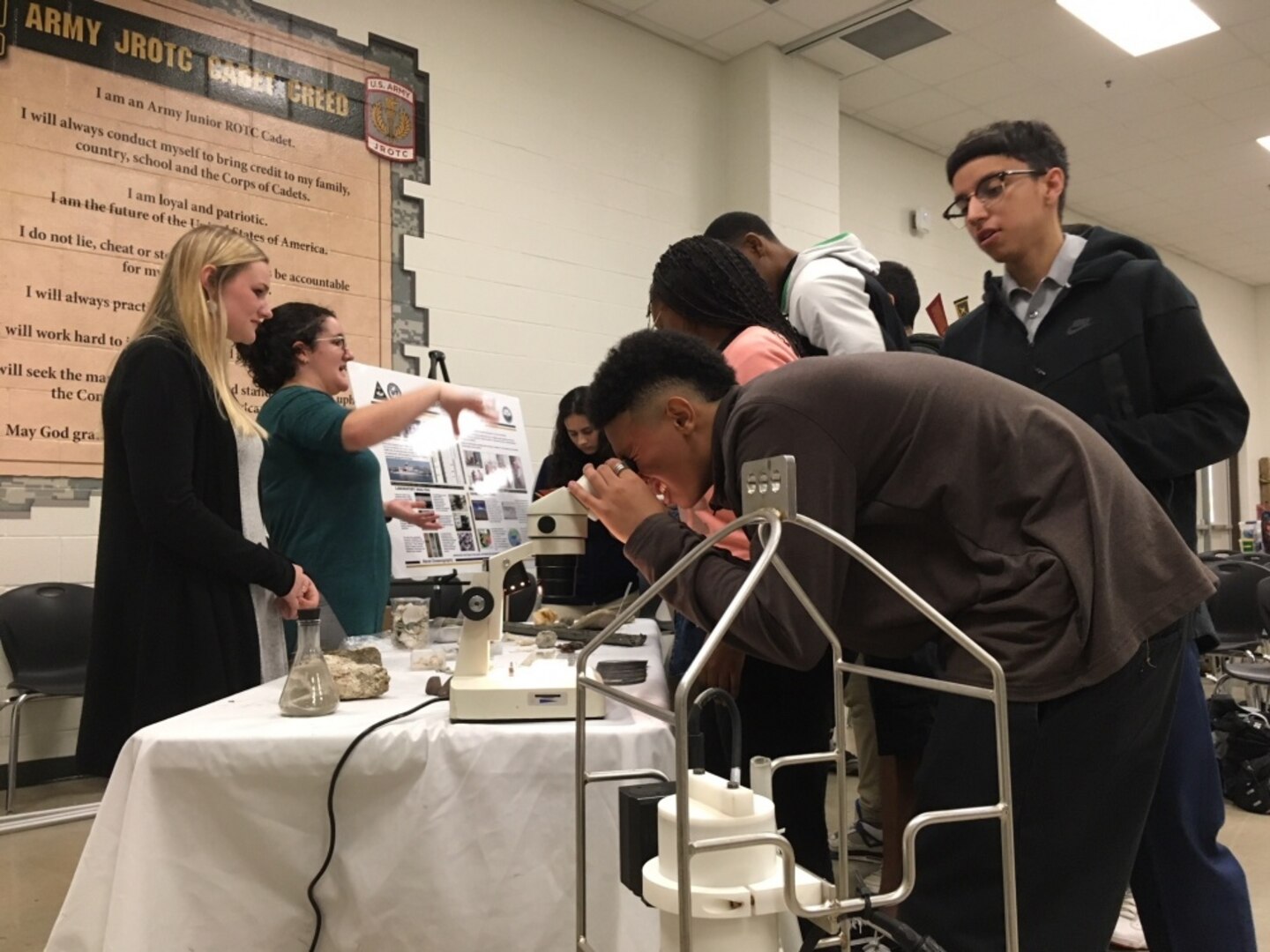 Naval Oceanographic Office geologists Sydne Workman and Sarah Holcomb explain the capabilities of the Navy's only operational geology lab Feb. 20 at Sam Houston High School during Navy Week San Antonio.