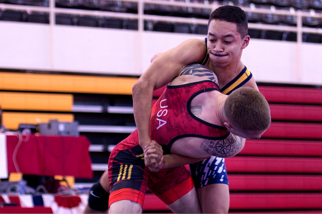 Navy Petty Officer 3rd Class Bobby Raines, top, competes against Marine Cpl. Nicholas Quillen in the 55 kg weight class during the 2018 Armed Forces Wrestling Championship Greco-Roman competition.