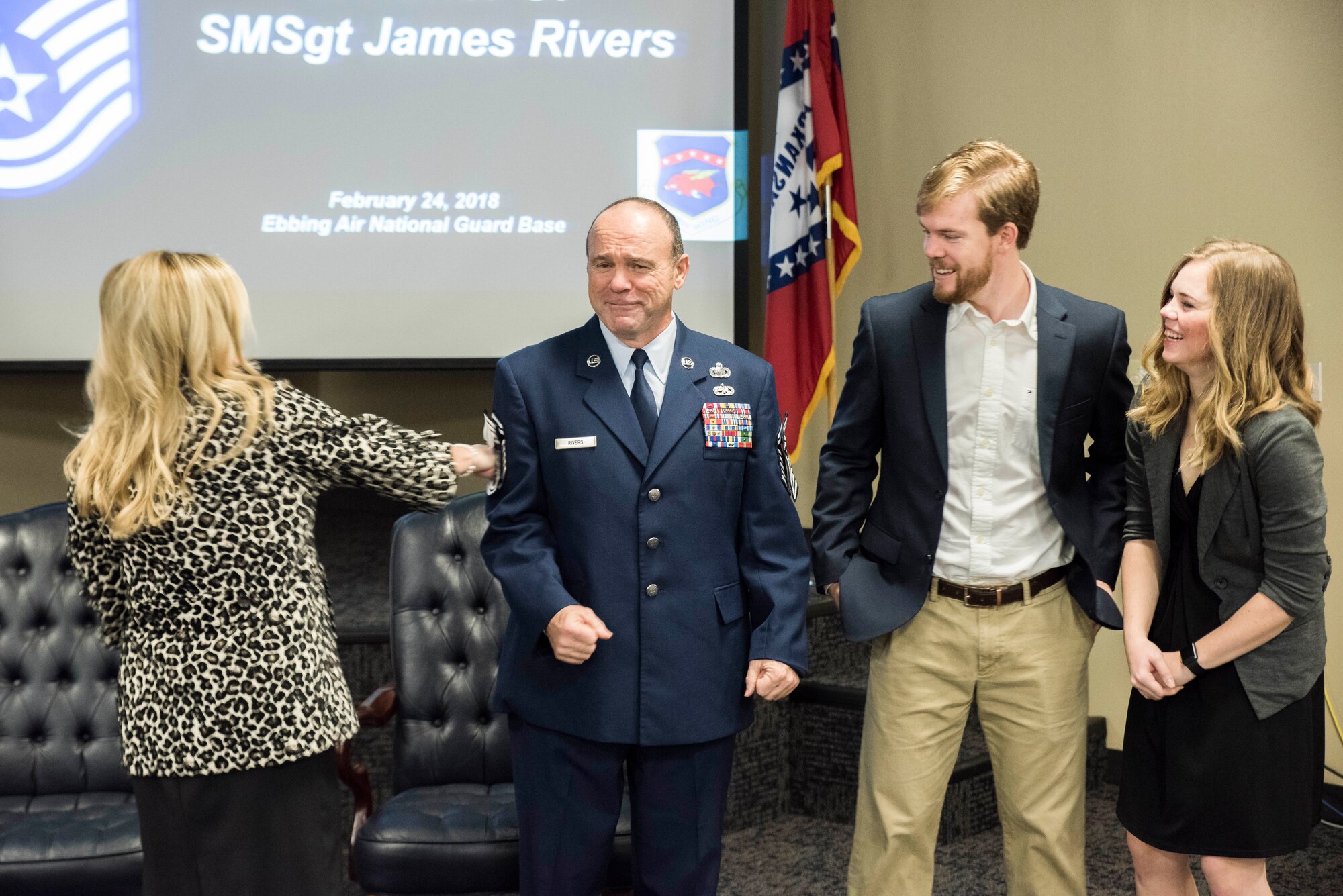James W. Rivers, 123rd Intelligence Squadron Superintendent, braces as family members tack on stripes during his Chief Master Sgt. Promotion at Ebbing Air National Guard Base, Fort Smith, Ark., Feb. 24, 2018.  Rivers enlisted in the Air Force in July, 1986, and has served vital roles in the intelligence community in both Active Duty and the Air National Guard. (U.S. Air National Guard photo by Senior Airman Matthew Matlock)
