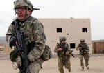 Soldiers with the Mississippi Army National Guard's 155th Armored Brigade Combat Team run for cover while engaging opposing forces during a rotation at the National Training Center, Fort Irwin, California, May 30, 2017.