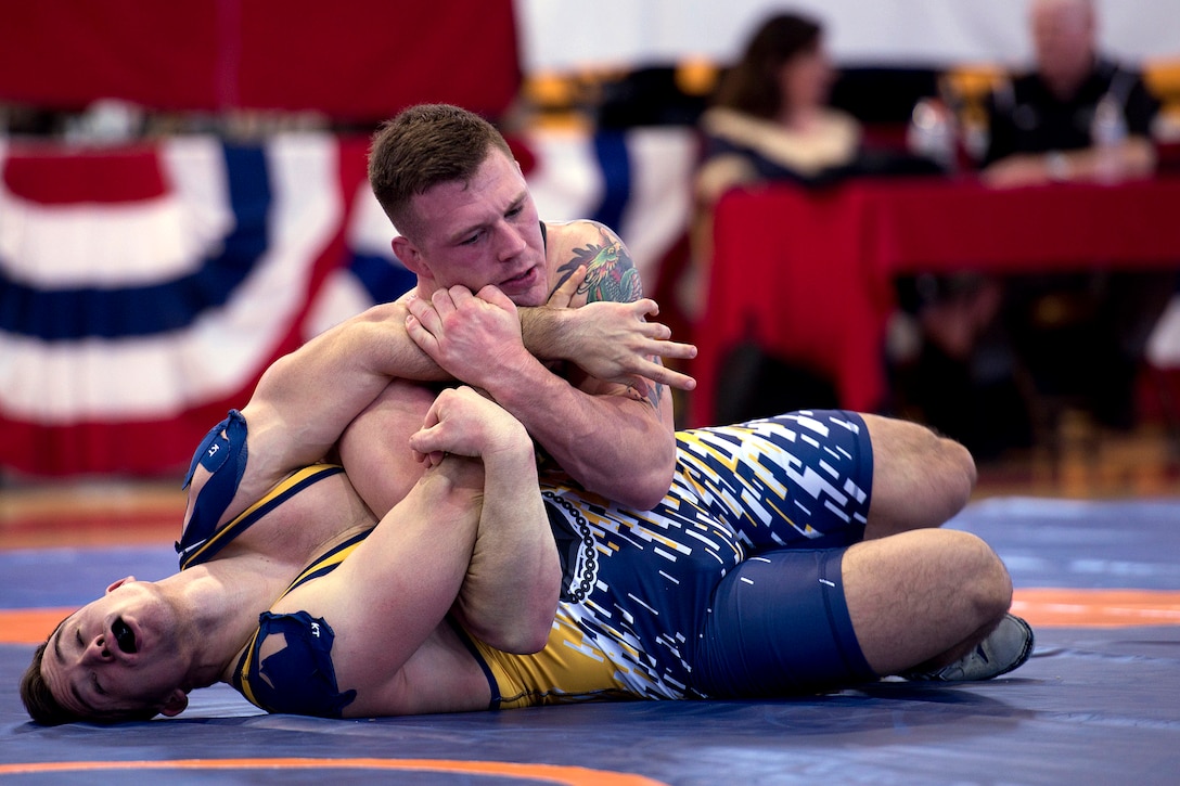 Marine Corps Sgt. John Stefanowicz, top, pins Navy Petty Officer 3rd Class Joseph Marques in the 82 kg weight class.
