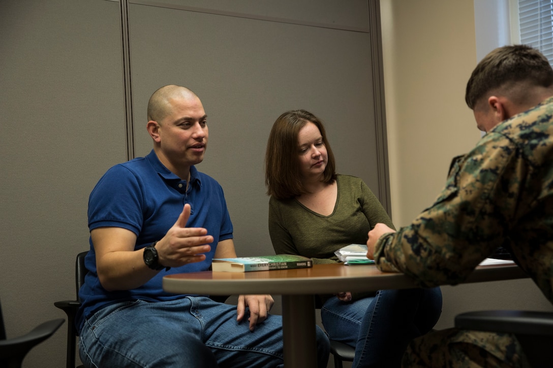 Gunnery Sgt. Micheal Riede and Stephanie Riede begin the process of filing their taxes with help from Cpl. Jesse Mineer at the tax center on Marine Corps Base Camp Lejeune, Feb. 13. The Marines and Sailors at the tax center are trained to help service members get back the most money possible. Mineer is a tax preparer at the tax center. (U.S. Marine Corps photo by Lance Cpl. Dominique Fisk)