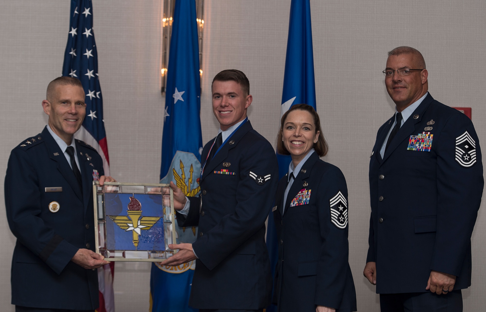 U.S. Air Force Airman 1st Class Dylan A. Jack, a client systems technician assigned to the 82nd Communications Squadron from Sheppard Air Force Base, Texas, receives the Air Education and Training Command Outstanding Airman of the Year Award from Lt. Gen. Steve Kwast, commander of AETC during the AETC 12 Outstanding Airmen of the Year Awards Banquet Feb. 22, 2018 in Orlando, Fla. Jack maintained $110 million cyber systems for 18,000 personnel and resolved 820 issues, deployed for six months to Air Force Central Command, and secured $230 million in projects, as well as lead a three-member team in completing six communications projects, worth $7 million. (U.S. Air Force photo by Staff Sgt. Kenneth W. Norman)